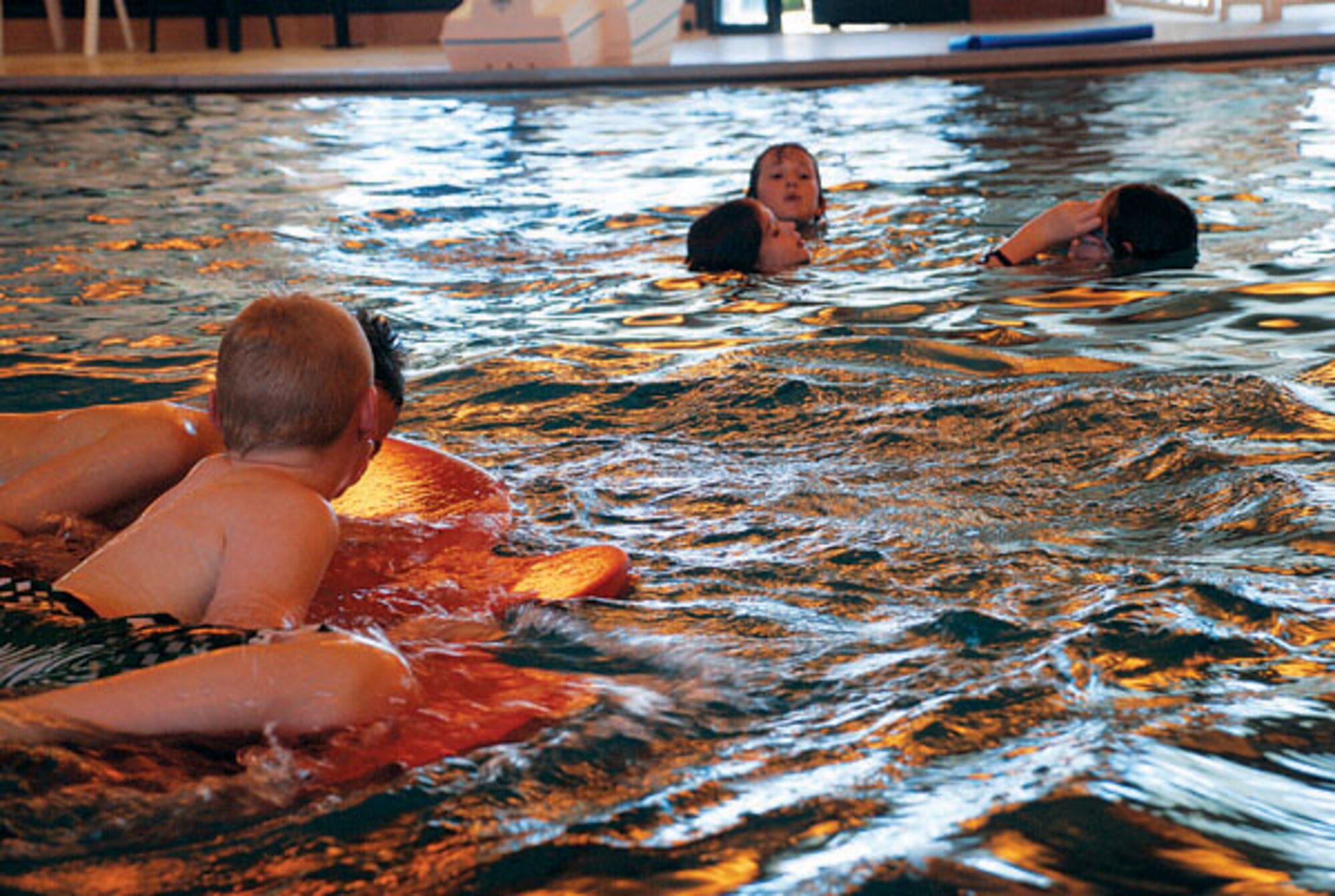 Children swim in the pool in the Warren Aquatic Center during the Spooky Swim Saturday.