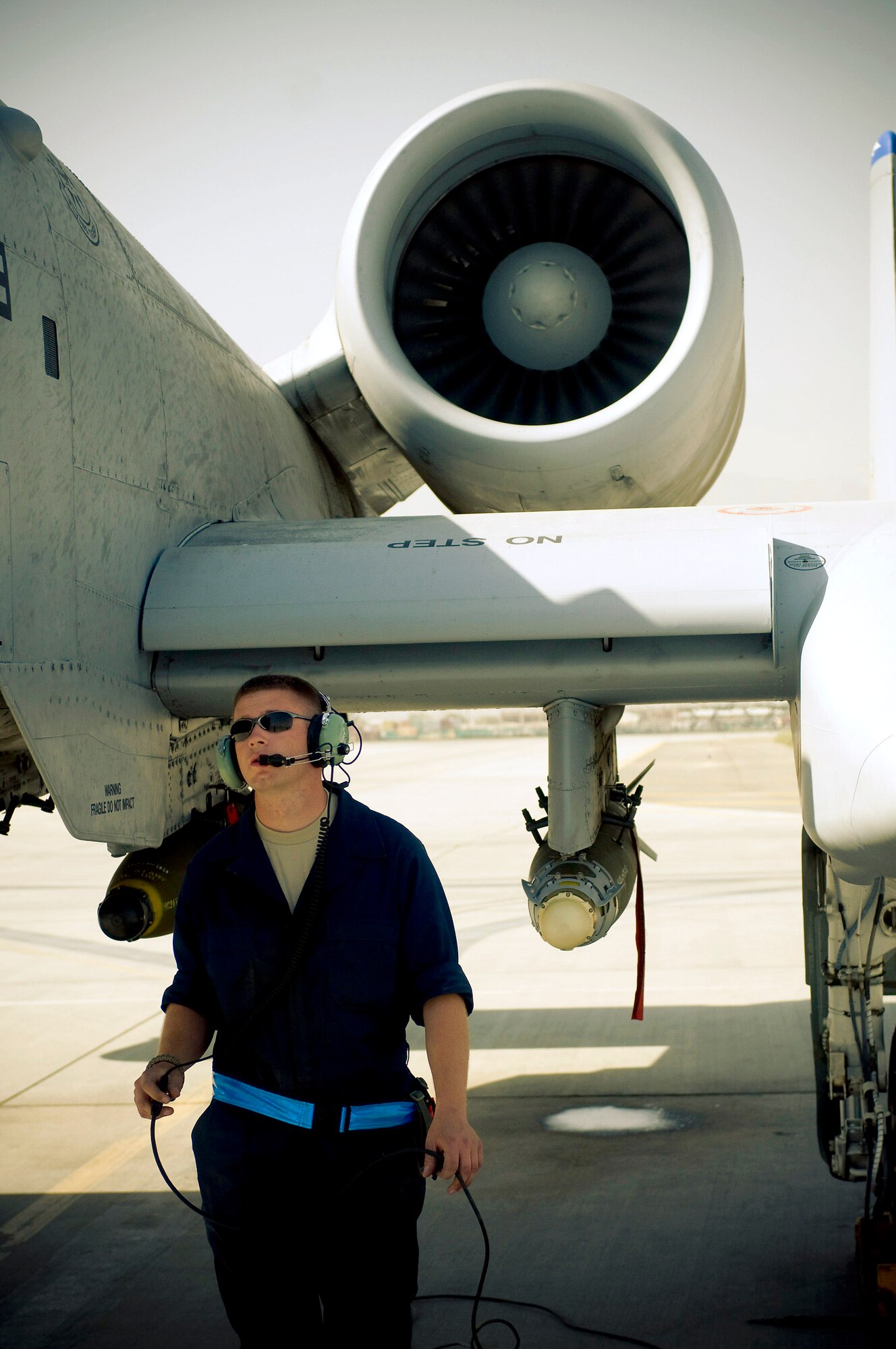 Senior Airman Benjamin Connery walks to the front of an A-10 Thunderbolt II to check the air-refueling door Oct. 18 at Bagram Airfield, Afghanistan. Airman Connery is a 455th Expeditionary Aircraft Maintenance Squadron A-10 crew chief and deployed from Moody Air Force Base, Ga. He is from Cashmere, Wash. (U.S. Air Force photo/Staff Sgt. Samuel Morse) 
