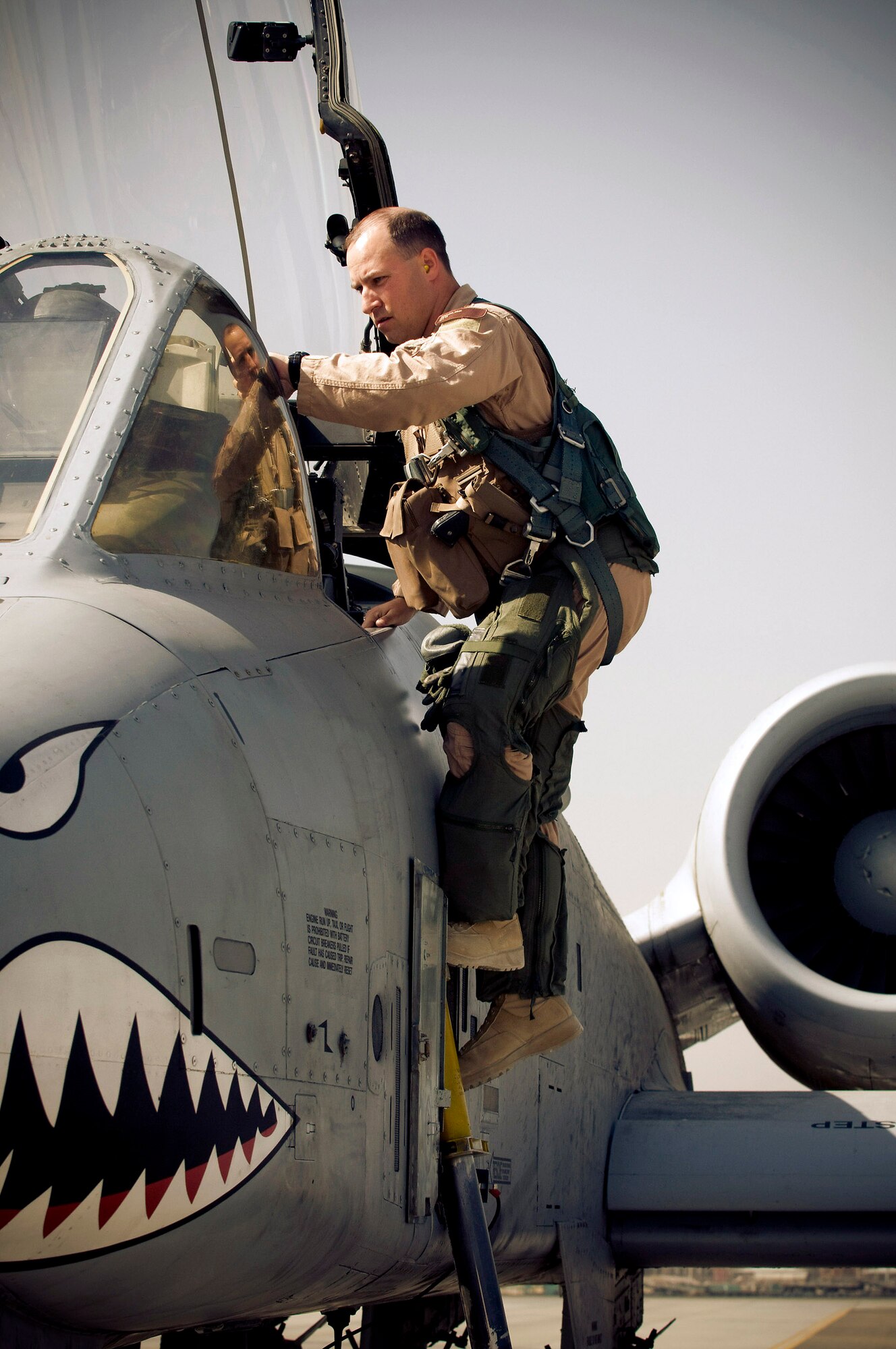 Maj. Erik Knauff climbs into an A-10 Thunderbolt II Oct. 18 at Bagram Airfield, Afghanistan. Major Knauff is a 455th Air Expeditionary Wing flight safety officer and pilot and deployed from Moody Air Force Base, Ga. He is from Perry Hall, Md. (U.S. Air Force photo/Staff Sgt. Samuel Morse) 
