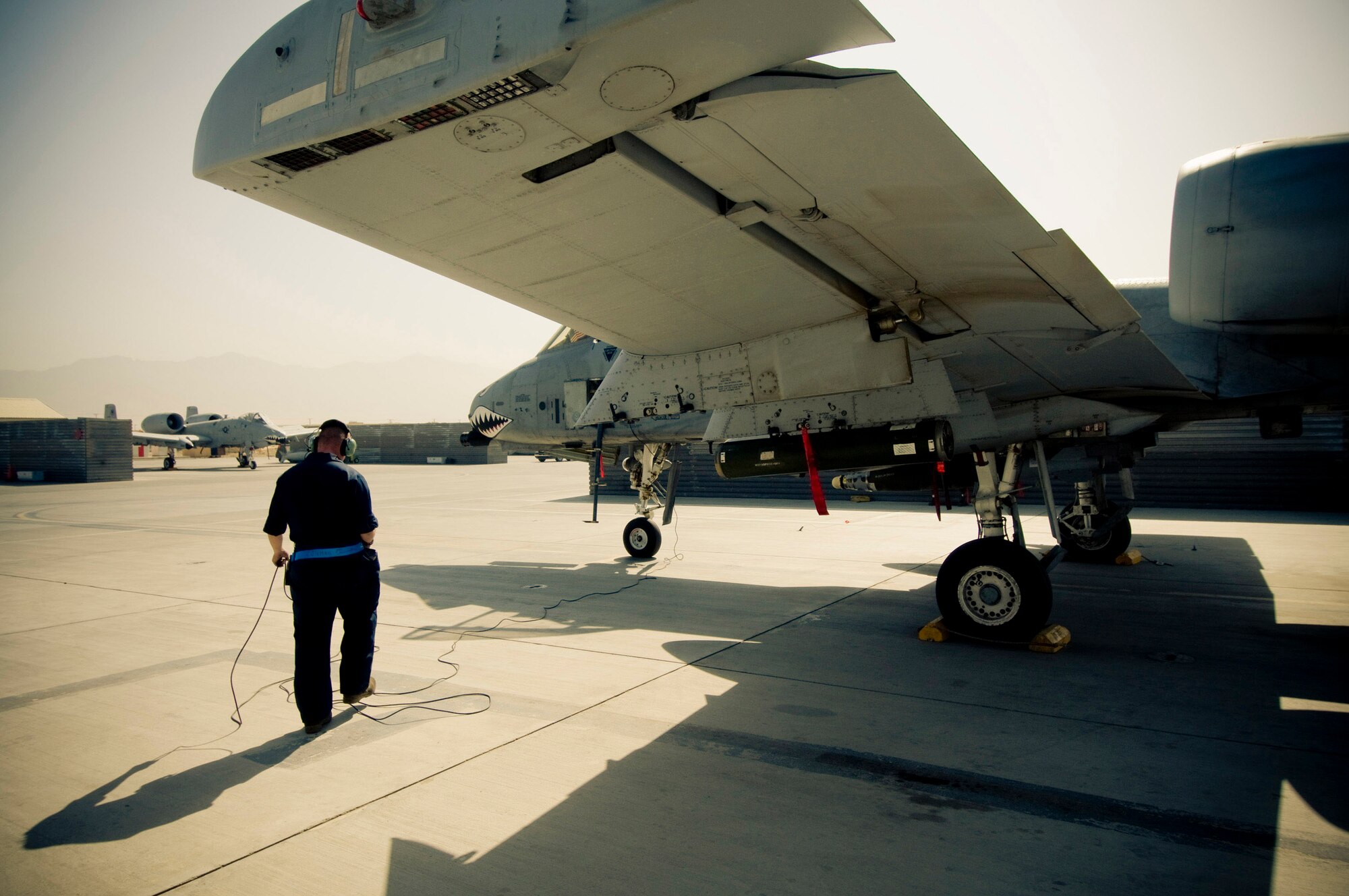 Senior Airman Benjamin Connery waits for the pilot to get set in his cockpit to begin to power-up an A-10 Thunderbolt II Oct. 18 at Bagram Airfield, Afghanistan. Airman Connery is a 455th Expeditionary Aircraft Maintenance Squadron A-10 crew chief and deployed from Moody Air Force Base, Ga. He is from Cashmere, Wash. (U.S. Air Force photo/Staff Sgt. Samuel Morse) 
