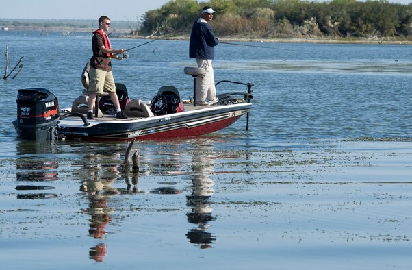 Senior Airman Marcus Creason (left) and Tech. Sgt Chuck Bunch work a weed bed for big bass during Fishing for Freedom V held Oct. 25 at Choke Canyon, Texas. Thirty-three injured servicemembers participated in the event. (U.S. Air Force photo/Master Sgt. Jack Braden)
