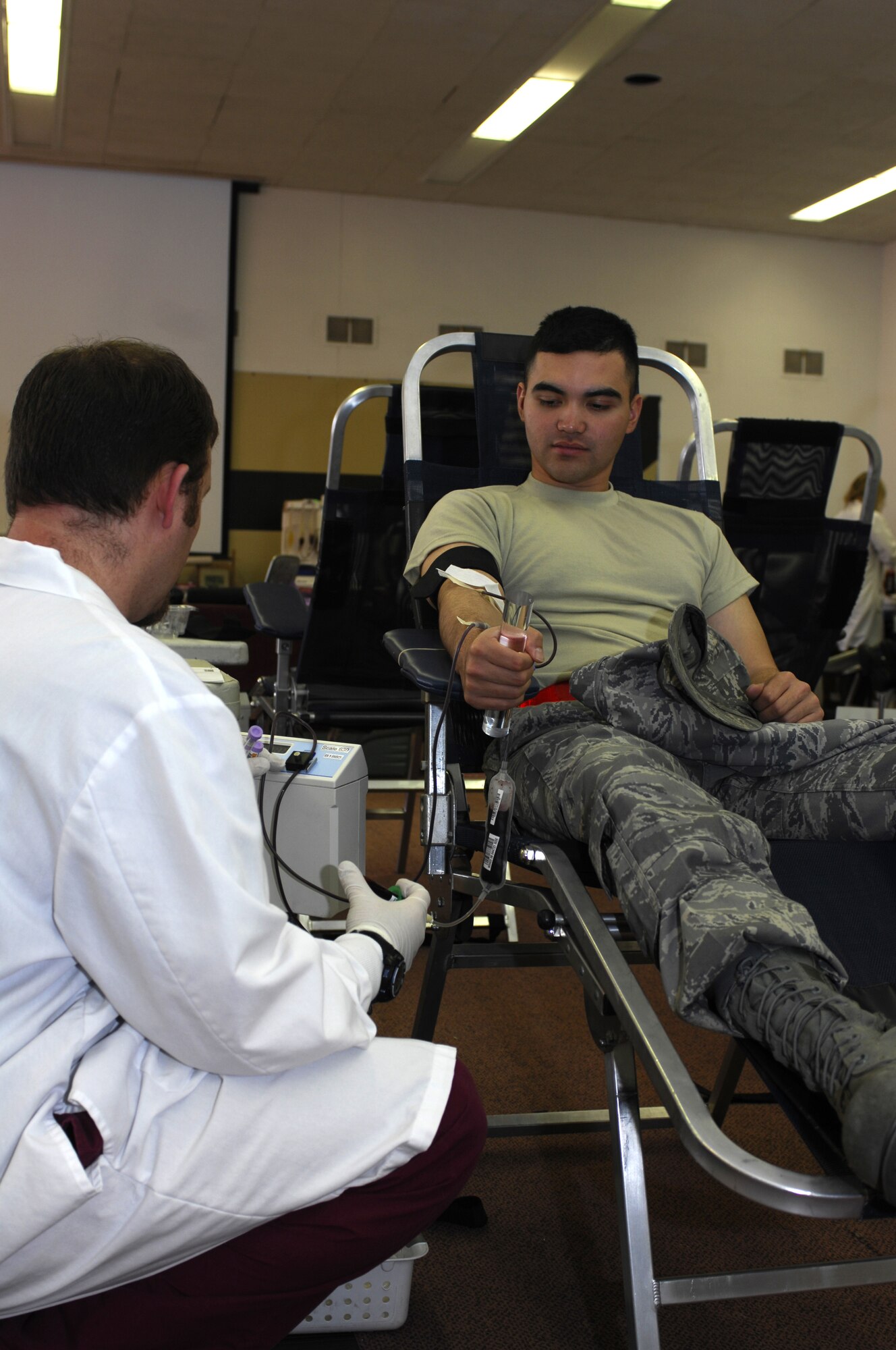 MINOT AIR FORCE BASE, N.D. -- Mathew Wiese, a United Blood Services nurse, monitors the blood flow of Senior Airman Arvin Candelaria, 5th Civil Engineer Squadron, during a blood drive here Oct. 29.  Members from the base volunteered their time to donate blood in support of more than 74 hospitals across N.D. (U.S. Air Force photo by Tech. Sgt. Lee A. Osberry Jr.)  