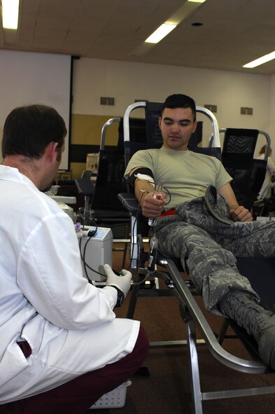 MINOT AIR FORCE BASE, N.D. -- Mathew Wiese, a United Blood Services nurse, monitors the blood flow of Senior Airman Arvin Candelaria, 5th Civil Engineer Squadron, during a blood drive here Oct. 29.  Members from the base volunteered their time to donate blood in support of more than 74 hospitals across N.D. (U.S. Air Force photo by Tech. Sgt. Lee A. Osberry Jr.)  