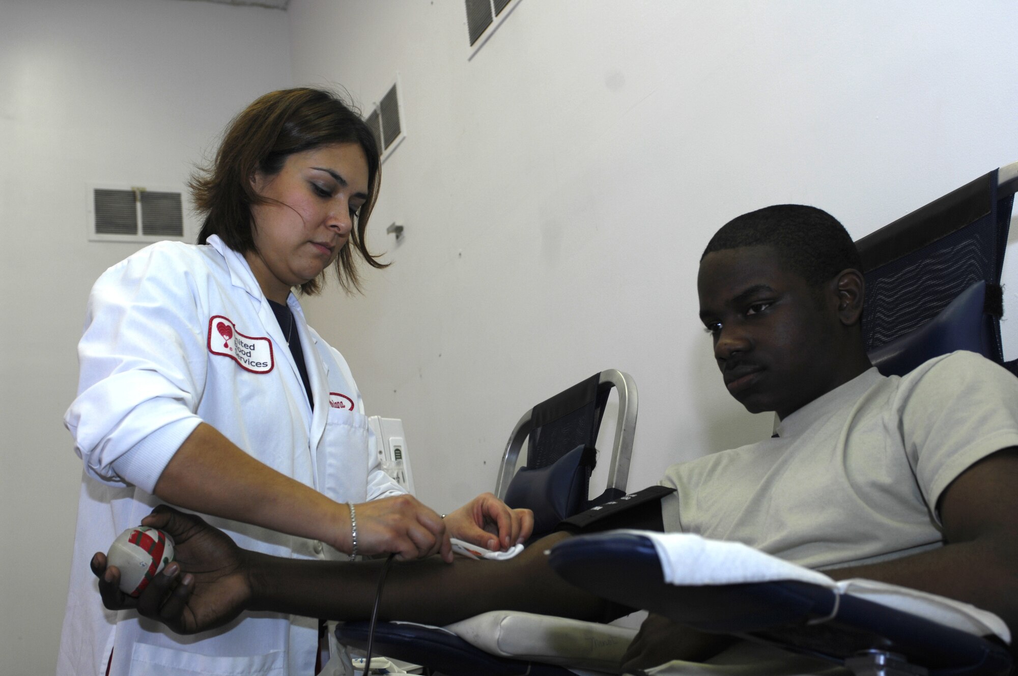 MINOT AIR FORCE BASE, N.D. -- Adriana Bueno, a United Blood Services nurse, attends to Airman 1st Class Jantzen Stroman, 91st Missile Maintenance Squadron, during a blood drive here Oct. 29. Members from the base volunteered their time to donate blood in support of more than 74 hospitals across N.D. (U.S. Air Force photo by Tech. Sgt. Lee A. Osberry Jr.)  
