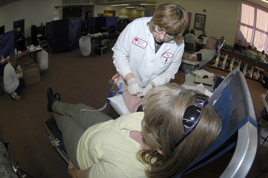 MINOT AIR FORCE BASE, N.D. -- Tess Bott, a United Blood Services nurse, inserts a needle into Karen Most, 5th Communications Squadron, during a blood drive here Oct. 29. Members from the base volunteered their time to donate blood in support of more than 74 hospitals across N.D. (U.S. Air Force photo by Tech. Sgt. Lee A. Osberry Jr.)  