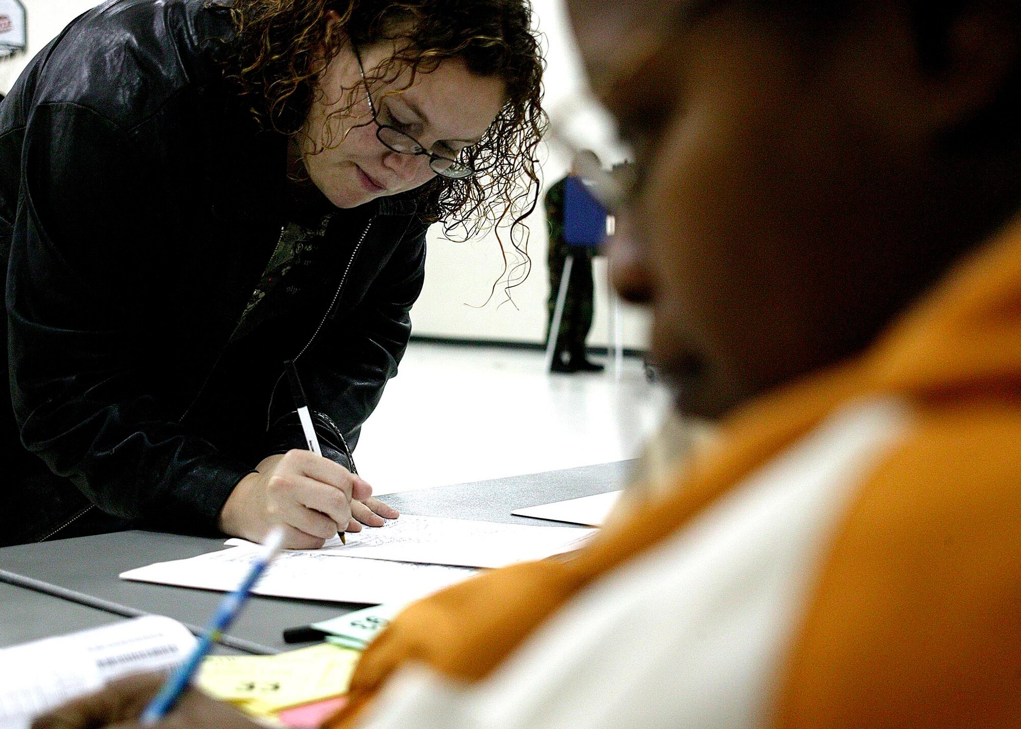 SHAW AIR FORCE BASE, S.C.-- Renee Robinson, a military dependent from Wisconsin, signs in to vote for her first time at Shaw Heights Elementary School here Nov. 4. The 1,076 registered voters of the Shaw precinct were able to vote from 7 a.m. to 7 p.m. (U.S. Air Force photo/Staff Sgt. Holly Brown)