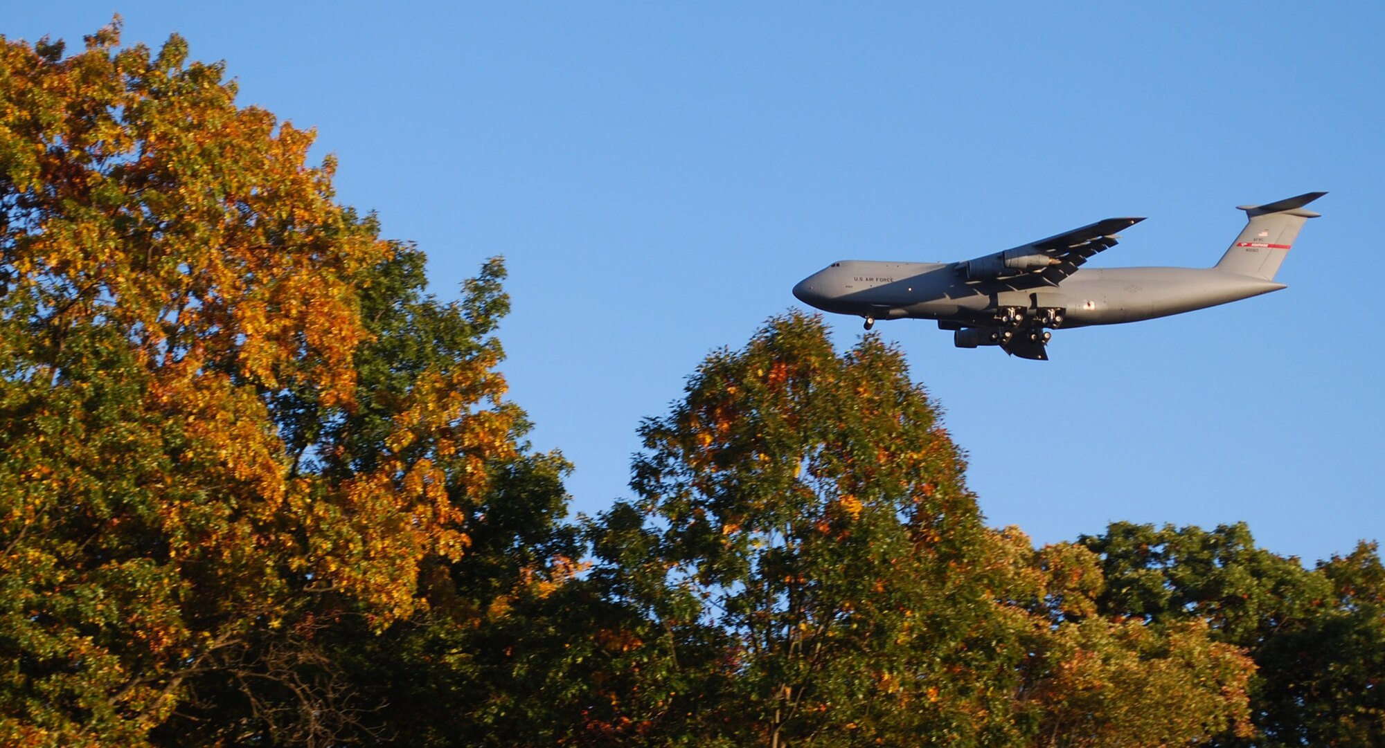 The trademark foliage of New England appears to surround a Patriot Wing C-5 preparing to land at Westover. The mission of the 439th Airlift Wing is worldwide strategic airlift. The C-5 is the largest aircraft in the Air Force. (US Air Force photo/Tech. Sgt. Andrew Biscoe)