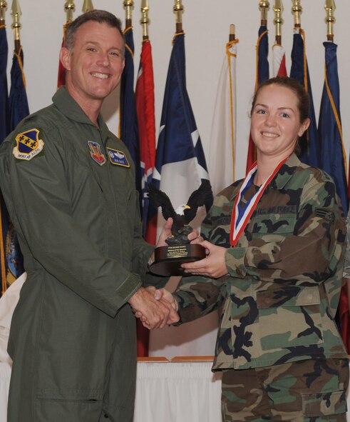 DYESS AIR FORCE BASE, Texas -- Colonel Robert Gass, 7th Bomb Wing commander, poses with Senior Airman Adrian Eckert, 7th Contracting Squadron, after she was named Team Dyess Airman of the Quarter Oct. 29. (U.S. Air Force photo by Senior Airman Courtney Richardson)