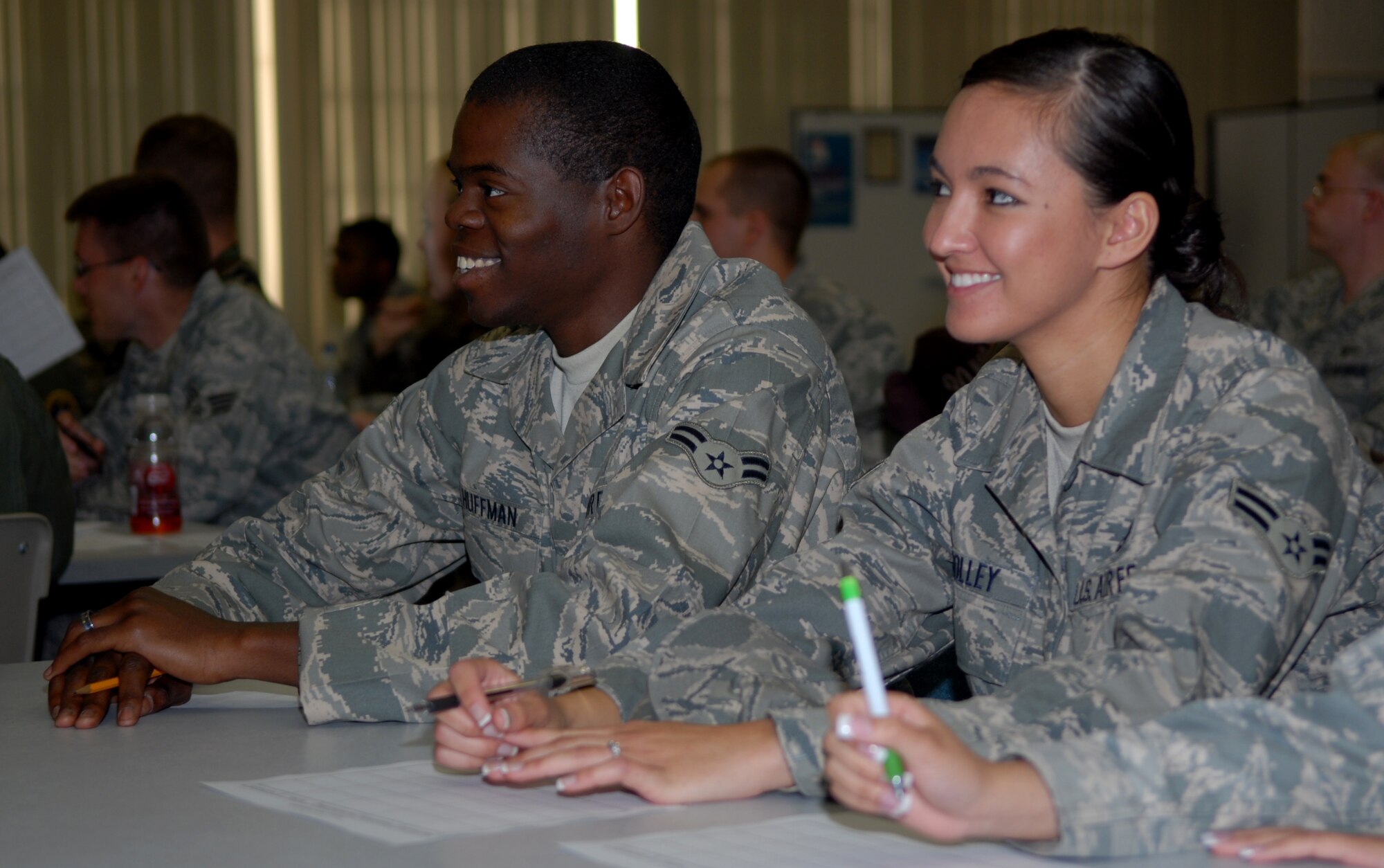 VANDENBERG AIR FORCE BASE, Calif.-- Airman 1st Class Julian Huffman and Airman 1st Class Melanie Solley, 30th Logistic Readiness Squadron, view a powerpoint on team development in order to complete their charts at the Junior Enlisted Emerging Professionally at the base education center. ( U. S. Air Force photo/Airman 1st Class Antoinette Lyons)