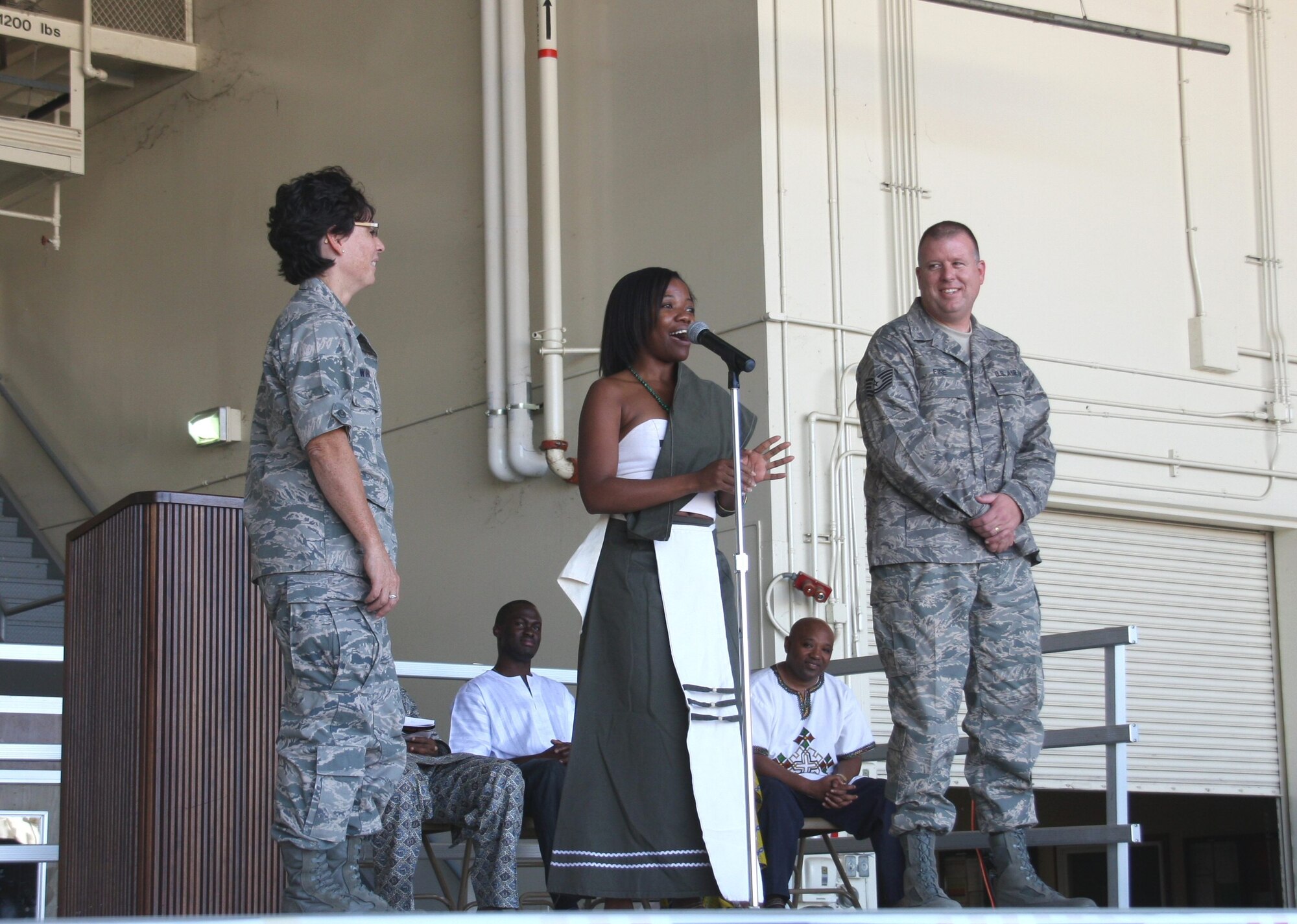 Pellagia Muliba, a student at the Thunderbird School of Global Management, demonstrates traditional African greetings to the 944th Fighter Wing using two volunteers, Maj. Haley Wihongi and Tech. Sgt. Jeff Fine. Major Wihongi is the 944th FW process manager and Sergeant Fine is the 944th FW historian. (U.S. Air Force photo/Lt. Col. Henry Detwiler)