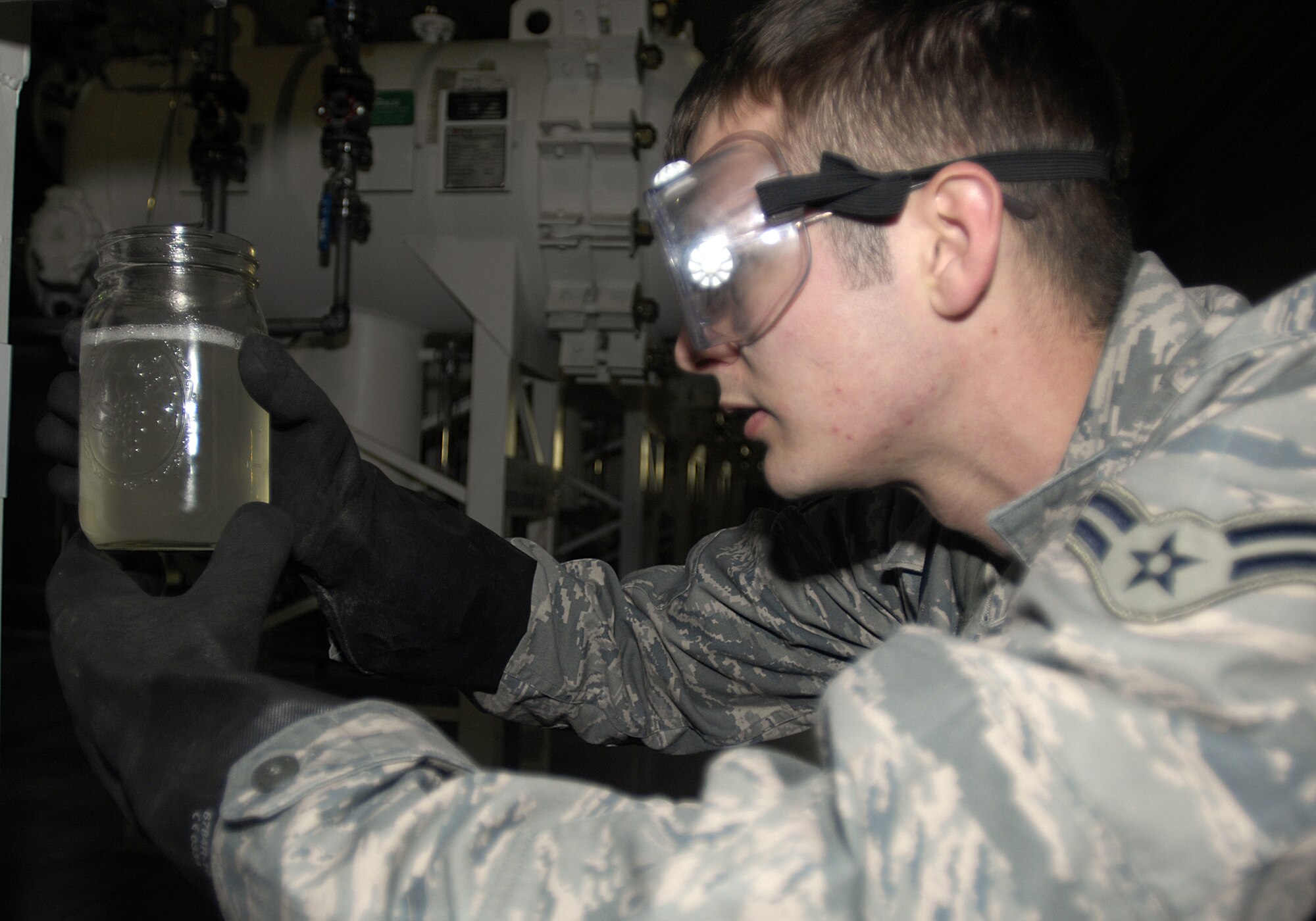 MINOT AIR FORCE BASE, N.D. — Airman 1st Class Jacob Hefley, 5th Logistics Readiness Squadron refueling unit operator, looks at the fuel clearness to ensure it has been properly filtered here Oct. 29. The purification of fuel is a vital aspect of the successful mission of a B-52H Stratofortress. (U.S. Air Force photo by Airman 1st Class Jesse Lopez)