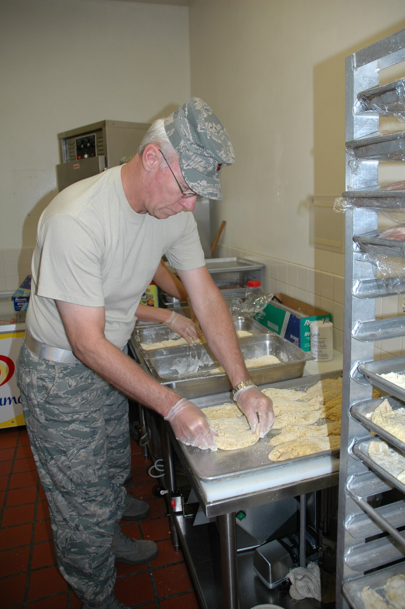 Maj. John Nuttall, 944th Services Flight commander, breads catfish for the 944th Fighter Wing's Unity Luncheon, an annual event celebrating unity and diversity within the wing. (U.S. Air Force photo/Staff Sgt. Louis Vega)
