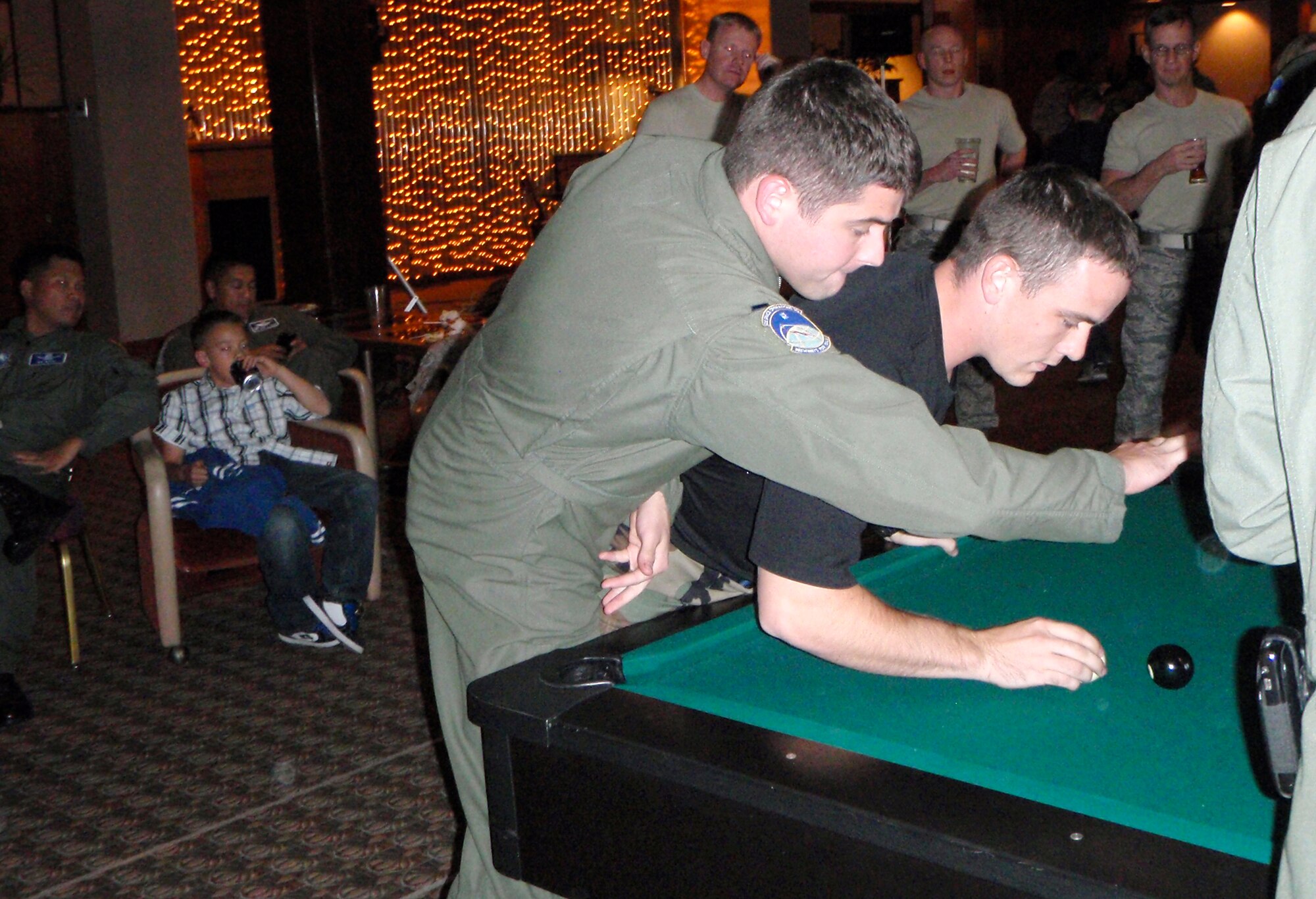 1st Lt. Daniel Boyd, 2nd  Space Operations Squadron, assays in vain to thwart 2nd Lt. Seth Lorimer, 21st Civil Engineer Squadron, shooting maneuver during the Oct. 17 officer CRUD tournament at the Peterson AFB Club. At the end of the tourney, the 21st Mission Support Group had recaptured the CRUD trophy from the 50th Space Wing.