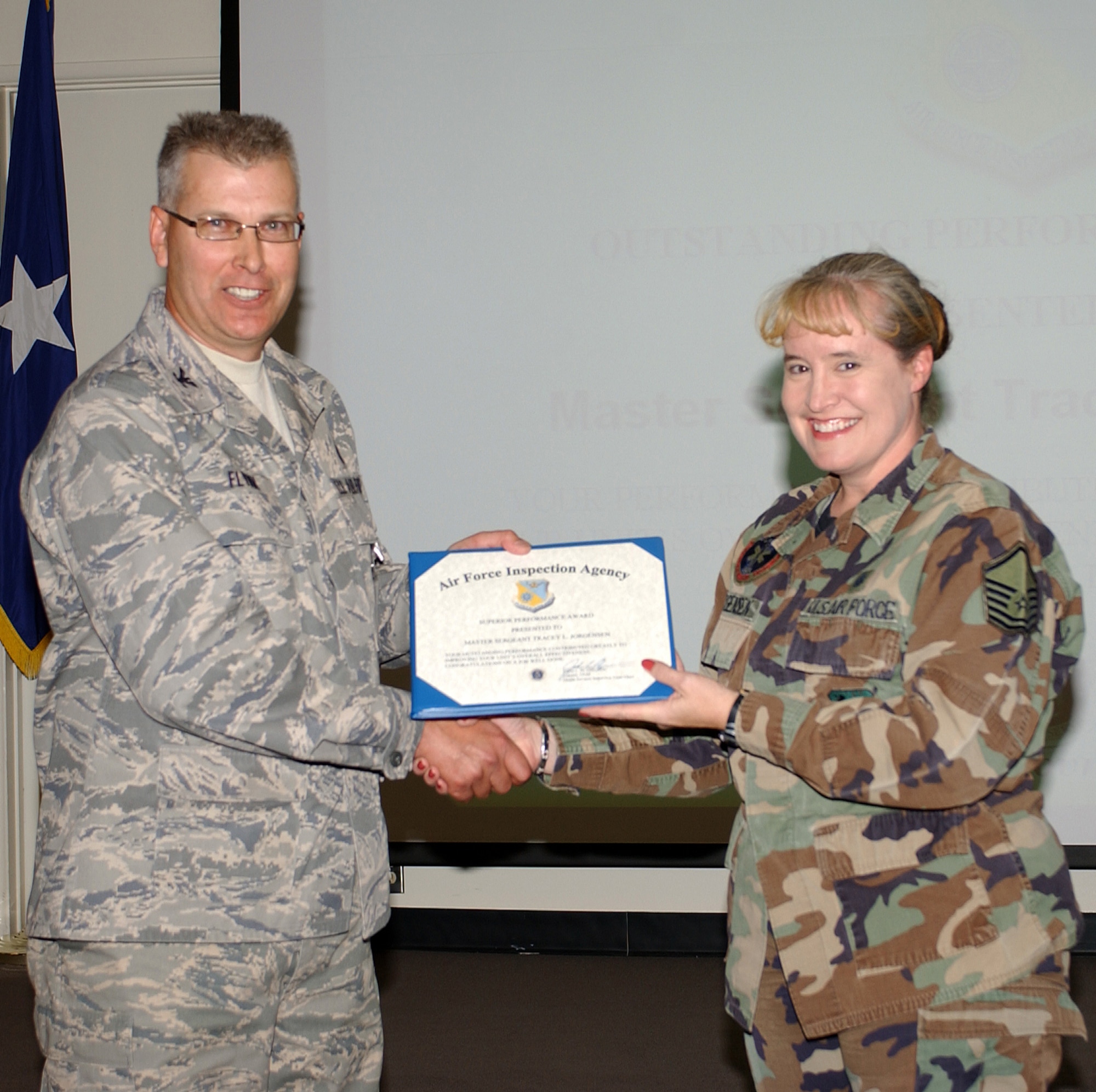 Team chief Col. John Flynn congratulates Master Sgt. Tracey Jorgensen for being an outstanding performer during the Health Services Inspection, Nov. 2. The wing’s medical group scored a 98 percent—the highest of 50 Air Reserve Component (ARC) HSI’s conducted this year by the Air Force Inspection Agency team. (Air National Guard photo by Senior Airman Sarah Elliott)