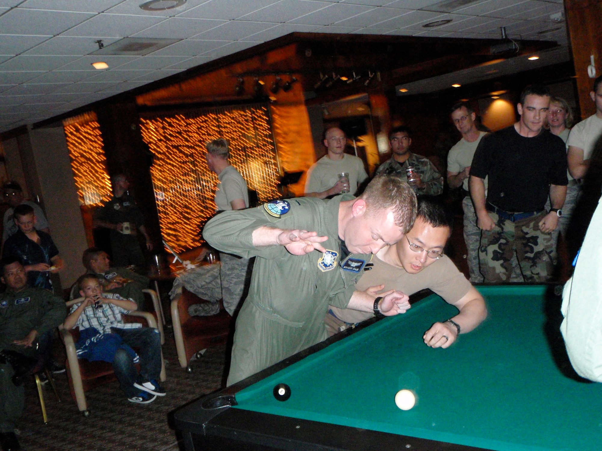 Capt. Robert Liu, 21st Civil Engineer Squadron, lunges for the shooter ball while 1st Lt. Brandon Bales, 50th Operations Support Squadron defends during the Oct. 17 officer CRUD tournament at the Peterson AFB Club. At the end of the tourney, the 21st Mission Support Group had recaptured the CRUD trophy from the 50th Space Wing. (Air Force photo/2nd Lt. Jonathan Simmons)