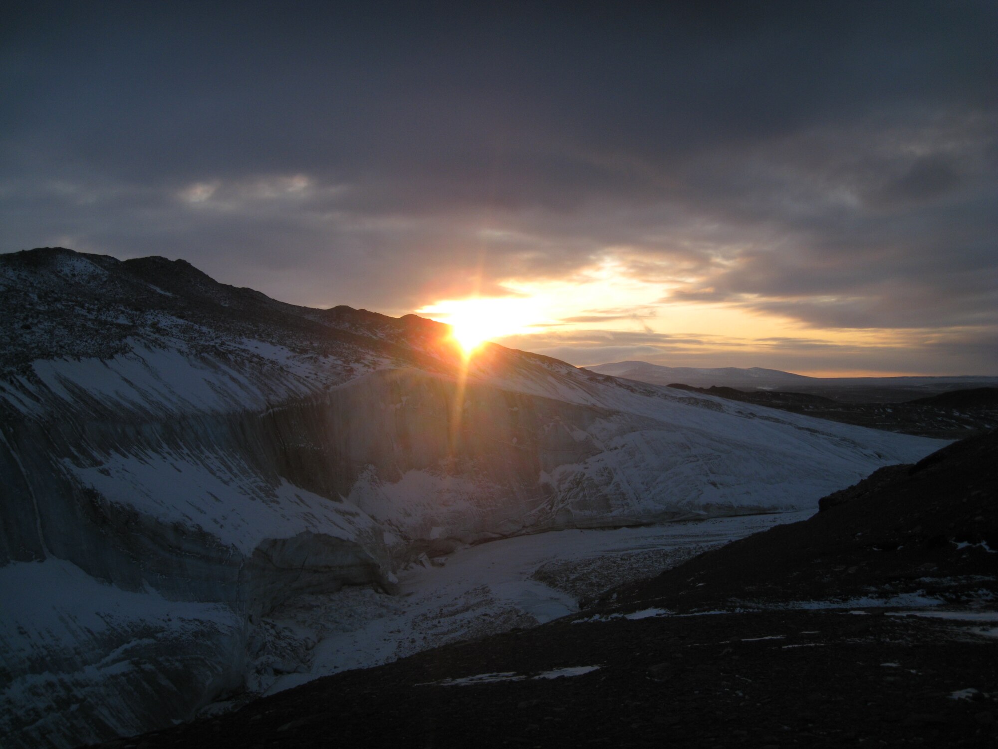 The sun sets behind P Mountain for one of its last times  of 2008 at Thule Air Base, Greenland. Oct. 31 marked the final sunset at Thule. The base will be under twilight until Nov. 22, when it will be under 24-hour darkness until twilight returns Jan. 21. During these times of twilight and darkness, the members of the 821st Air Base Group will continue to flawlessly effect space superiority through Air Force Core Values-based installation operations and protection. (Air Force photo/Capt. Alex Cusic) 