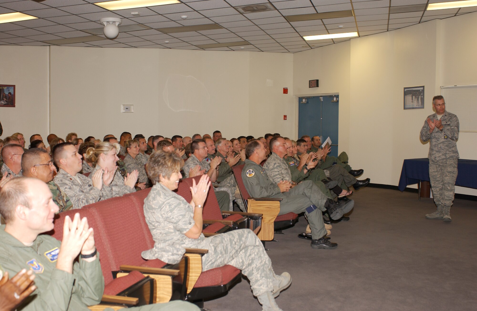 Guardsmen in the 162nd Fighter Wing auditorium break into cheers and applause when the “outstanding” Health Services Inspection (HSI) rating is revealed by inspection team chief Col. John Flynn, Nov. 2. The wing’s medical group scored a 98 percent—the highest of 50 Air Reserve Component (ARC) HSI’s conducted this year by the Air Force Inspection Agency team. (Air National Guard photo by Senior Airman Sarah Elliott)