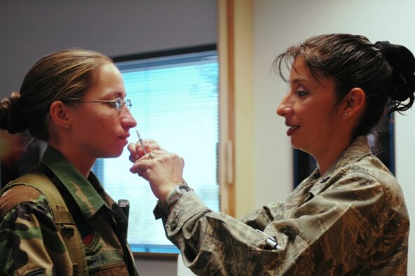 Staff Sgt. Haley Bia, a 162nd Security Forces Squadron member, receives a flu mist vaccine from Lt. Col. Jackie Federico-Lopez during a physical health assessment, Nov. 1. More than 98 percent of unit members are up to date with immunization requirements; a statistic vital to the success of the wing’s Health Services Inspection. (Air National Guard photo by Staff Sgt. Desiree Twombly)