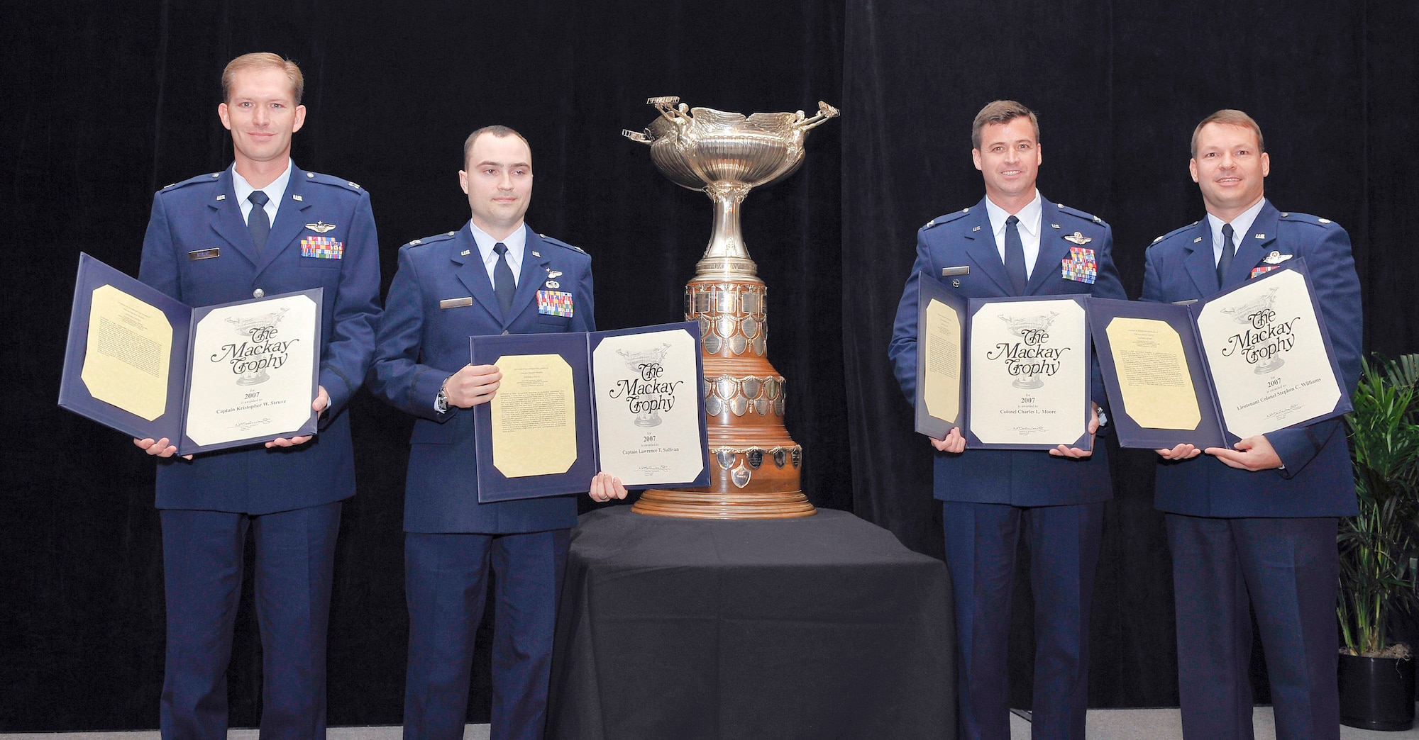Four F-16 Fighting Falcon pilots were honored Nov. 3 after being presented the Mackay Trophy.  The award honors the "most meritorious flight of the year."  Pictured with the trophy are Capt. Kristopher W. Struve (left), Capt. Lawrence T. Sullivan, Col. Charles L. Moore and Lt. Col. Stephen C. Williams.  (U.S. Air Force photo/Michael J. Pausic)