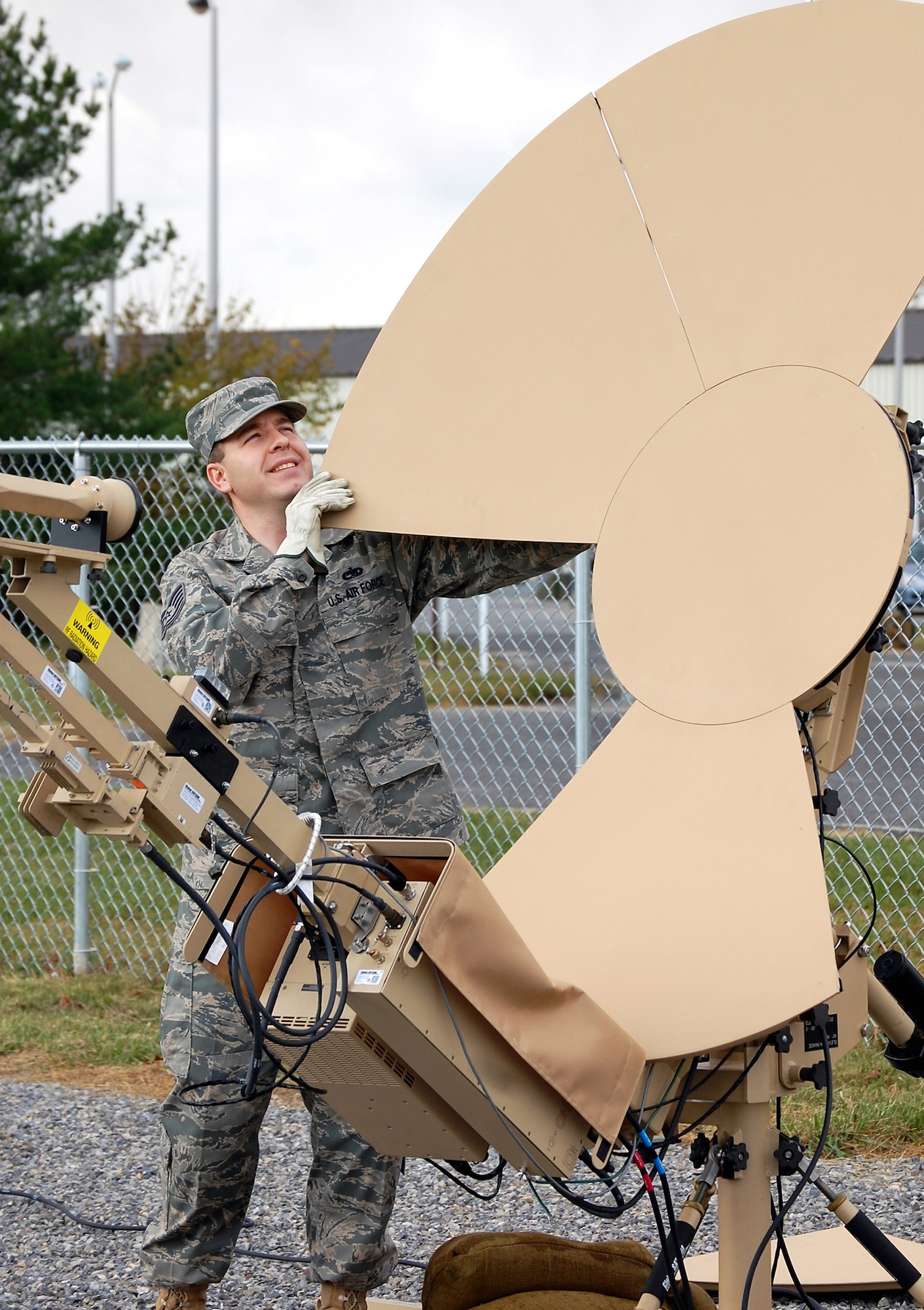 Tech. Sgt. Adrian McDonough prepares a satellite dish used in a Small Package Initial Communications Element package for training in the Mobility Operations School's mobile command, control and communications training facility on the expeditionary center campus Oct. 29 at Fort Dix, N.J. The SPICE Course is a new course in the MOS starting in February 2009. Sergeant McDonough is the course director for the U.S. Air Force Expeditionary Center's SPICE Course. (U.S. Air Force Photo/Tech. Sgt. Scott T. Sturkol)
