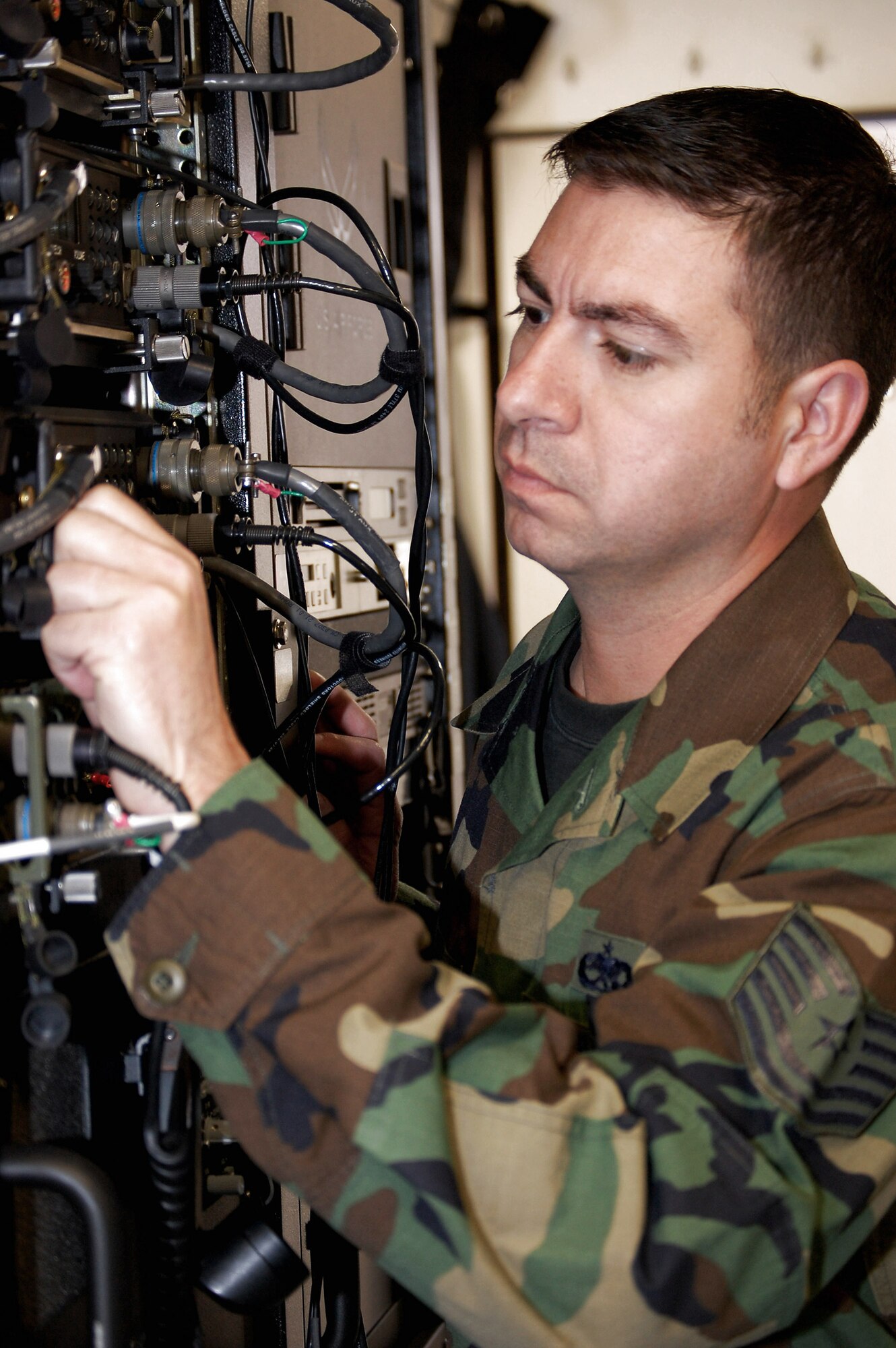 Tech. Sgt. Don Colbert works on adjusting an antenna on the Hard-sided Expandable Lightweight Air Mobile Shelter in the Mobility Operations School's Mobile C3 training facility Oct. 29 Fort Dix, N.J. Sergeant Colbert is the course director for the Air Force Expeditionary Center's Mobile Command, Control and Communications Systems Course. (U.S. Air Force photo/Tech. Sgt. Scott T. Sturkol)