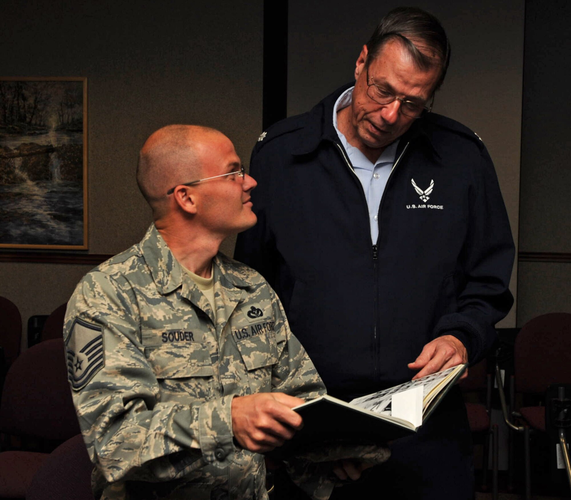 Master Sgt. William Souder and Lt. Col. James Wohlwend look at a high school yearbook printed in 1991. Colonel Wohlwend was Sergeant Souder's Air Force Junior Reserve Officer Training Corps commander at Derby High School in Derby, Kan. The colonel is still commander at the school and Sergeant Souder is now a Heating, Ventilation and Air Conditioning supervisor assigned to the 931st Civil Engineer Squadron. The two reunited 17 years after Sergeant Souder graduated from Derby when some of Colonel Wohlwend's cadets visited McConnell Air Force Base, Kan., on Oct. 30. The 931st CES is part of the 931st Air Refueling Group, an Air Force Reserve unit at McConnell. (U.S. Air Force photo/Tech. Sgt. Jason Schaap)