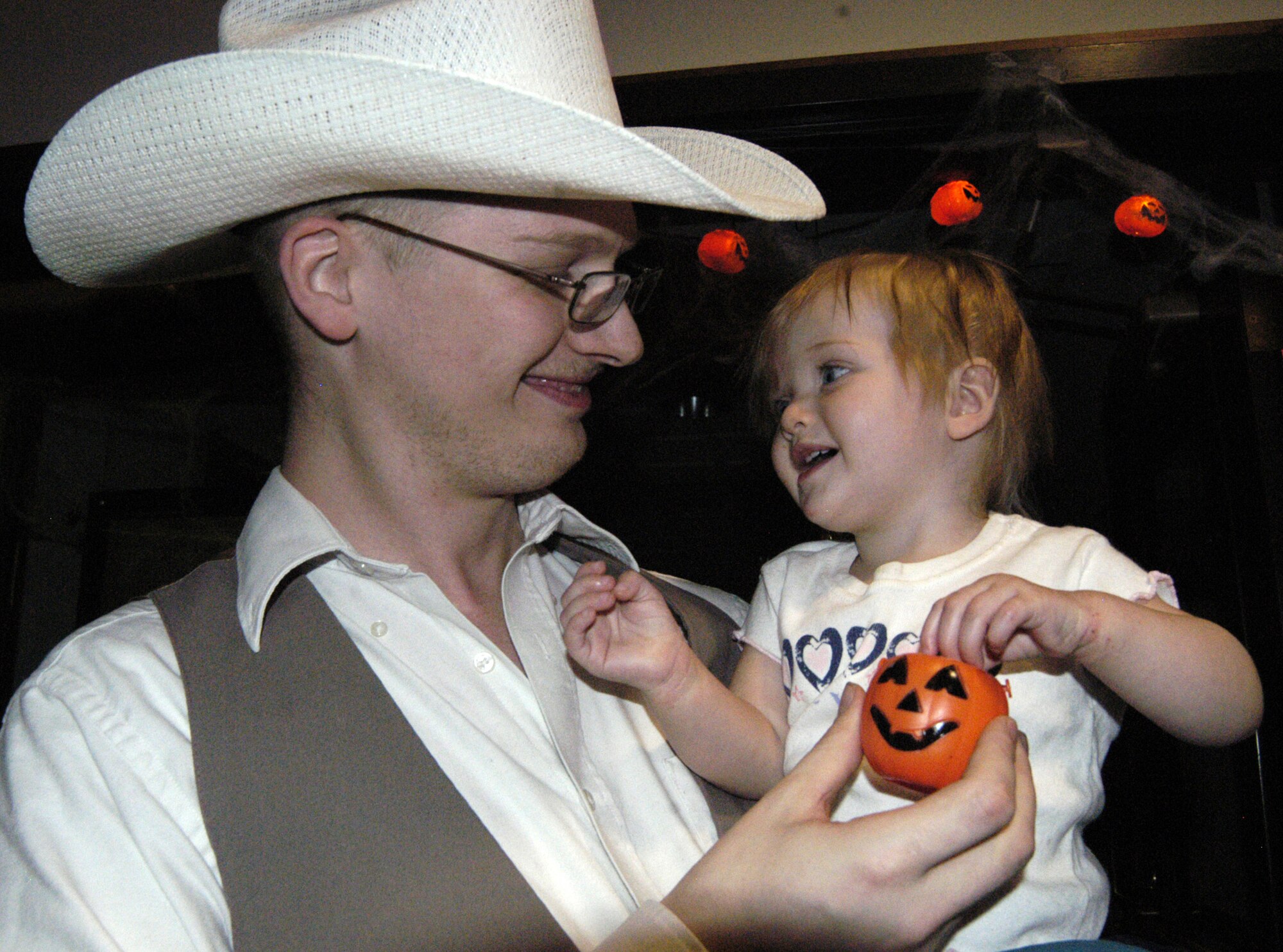 DOVER AIR FORCE BASE, Del. ? Airman 1st Class Richard Ketchel, 436th Maintenance Squadron, hands his daughter, Brianna, a treat during the Eagles Net Caf? Halloween Party hosted by the Chapel Oct. 31. (U.S. Air Force photo/Airman 1st Class Shen-Chia Chu)                                