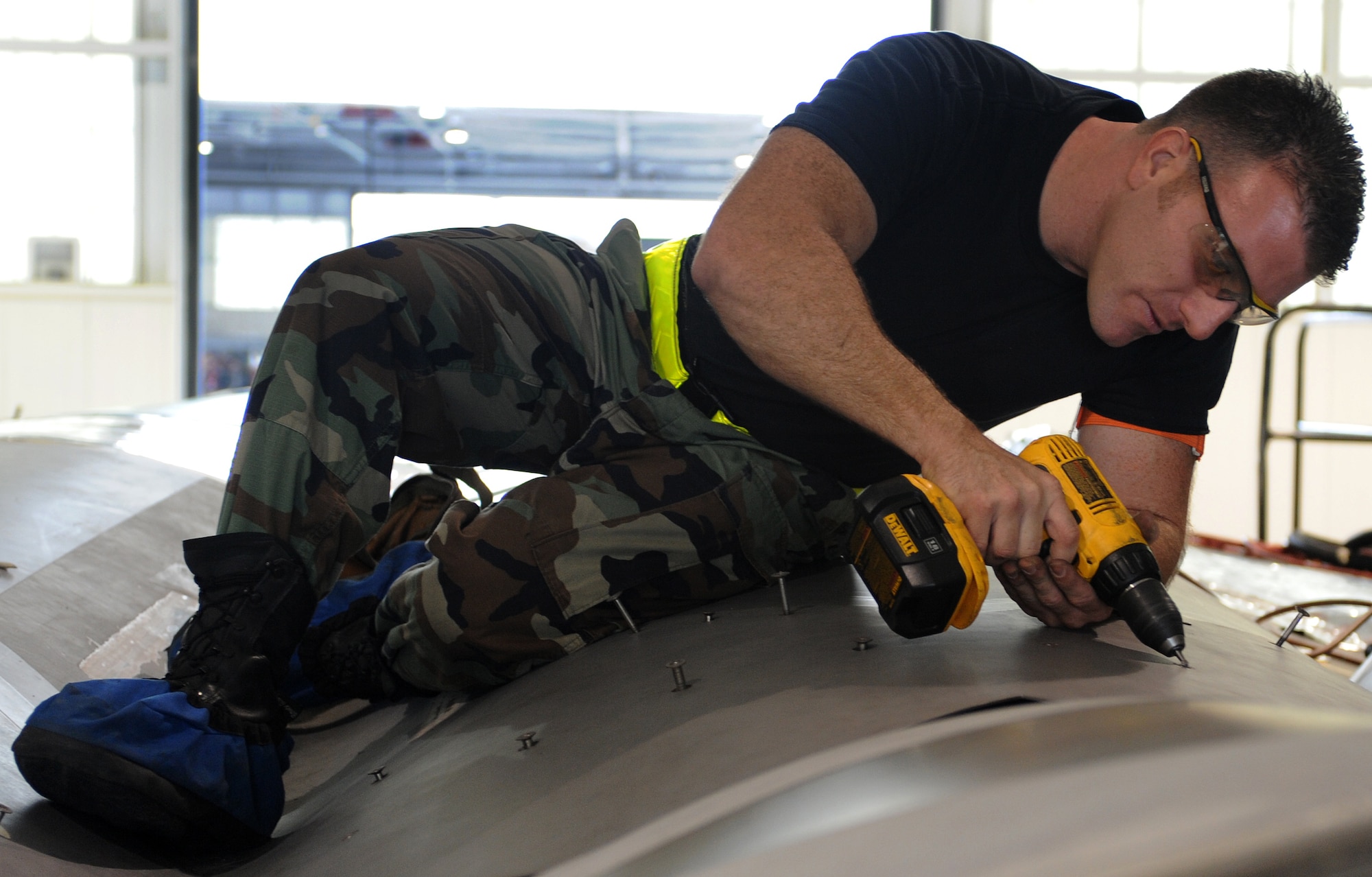 LANGLEY AIR FORCE BASE, Va. – Staff Sgt. Chase Whaley, 1st Equipment Maintenance Squadron aircraft metals technician, loosens a screw on the F-22A Raptor Oct. 17. Sheet metal performs physical repairs of the airframe.  (U.S. Air Force Photo/Airman 1st Class Zachary Wolf)