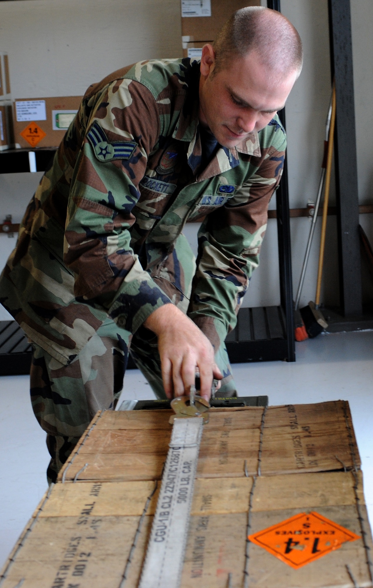 LANGLEY AIR FORCE BASE, Va. -- Senior Airman Robert Crockett, 1st Equipment Maintenance Squadron munitions storage crew member, secures ammunition before it is transported Oct. 17. The munitions flight provides the things that go boom. The flight can support any aircraft with missiles, bombs, small arms ammunition, and counter measures, including aircraft supporting Operation Noble Eagle.  (U.S. Air Force Photo/Airman 1st Class Zachary Wolf)