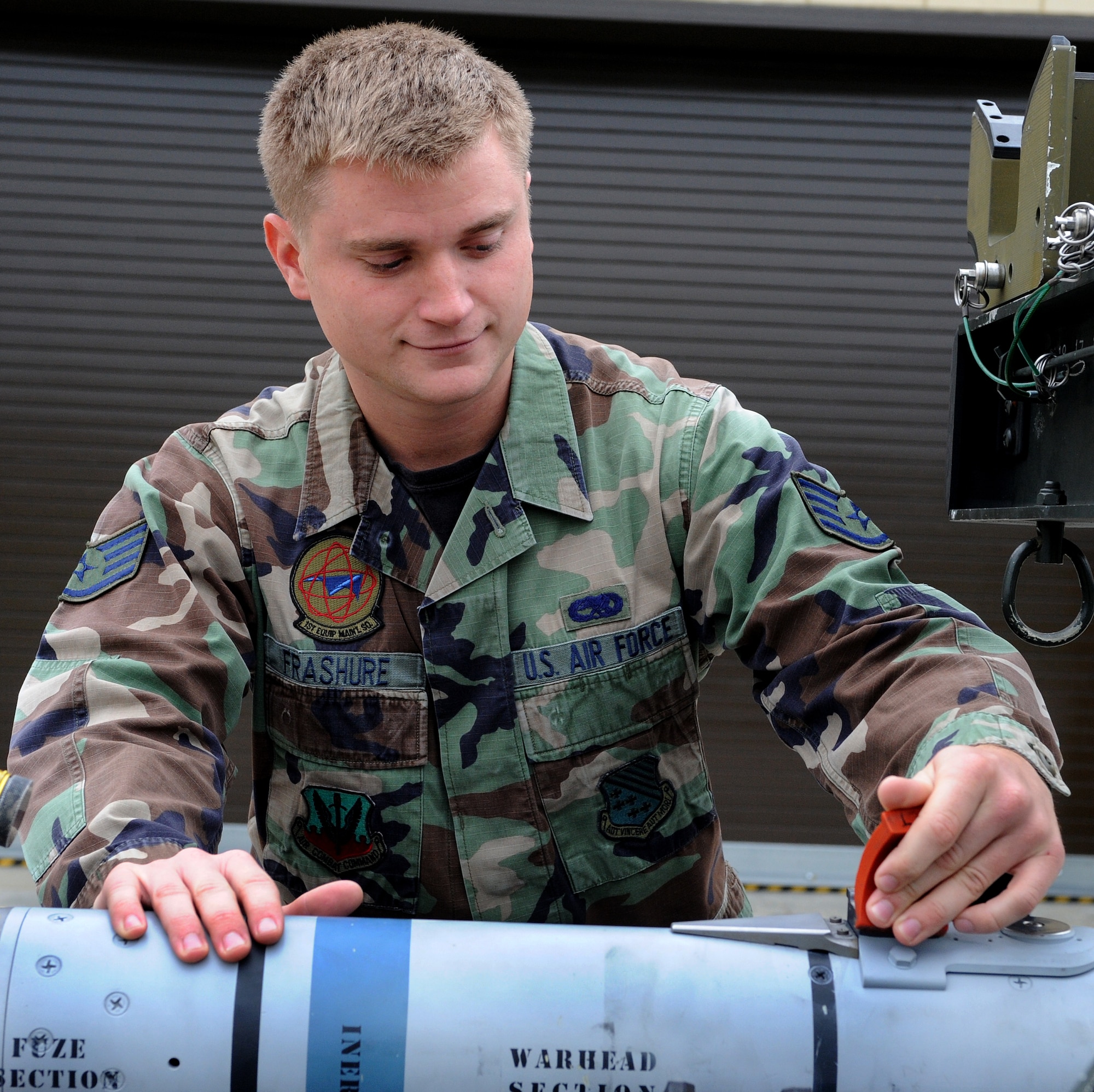 LANGLEY AIR FORCE BASE, Va. – Staff Sgt. Adam Frashure, 1st Equipment Maintenance Squadron precision guided munitions technician, performs a post load inspection on a missile Oct. 17. The munitions flight provides the things that go boom. The flight can support any aircraft with missiles, bombs, small arms ammunition, and counter measures, including aircraft supporting Operation Noble Eagle.  (U.S. Air Force Photo/Airman 1st Class Zachary Wolf)