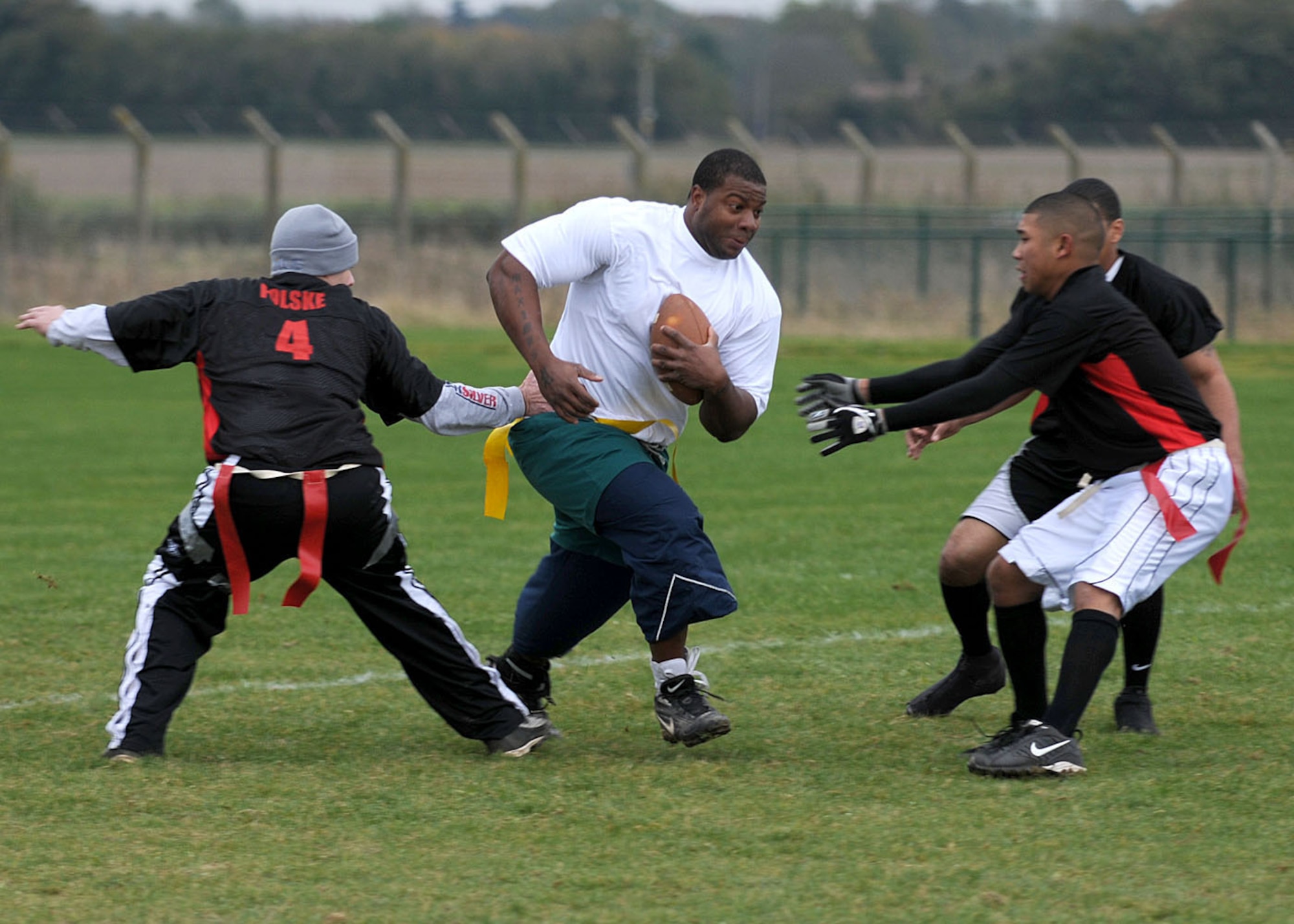 Perry Davis from the 100th Communications Squadron plows through the 100th Logistics Readiness Squadron’s defense during the flag football championship game Nov. 1, 2008, at RAF Mildenhall, England. The communications squadron defeated the logistics readiness squadron with a 1 point victory with the final score of 14-13. (U.S. Air Force photo by Staff Sgt. Jerry Fleshman)