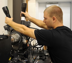 LANGLEY AIR FORCE BASE, Va. – Airman 1st Class Dominick Intorre, 1st Equipment Maintenance Squadron precision guided munitions technician, secures a missile in order to begin testing the guidance control system Oct. 17. The munitions flight provides the things that go boom. The flight can support any aircraft with missiles, bombs, small arms ammunition, and counter measures, including aircraft supporting Operation Noble Eagle.  (U.S. Air Force Photo/Airman 1st Class Zachary Wolf)