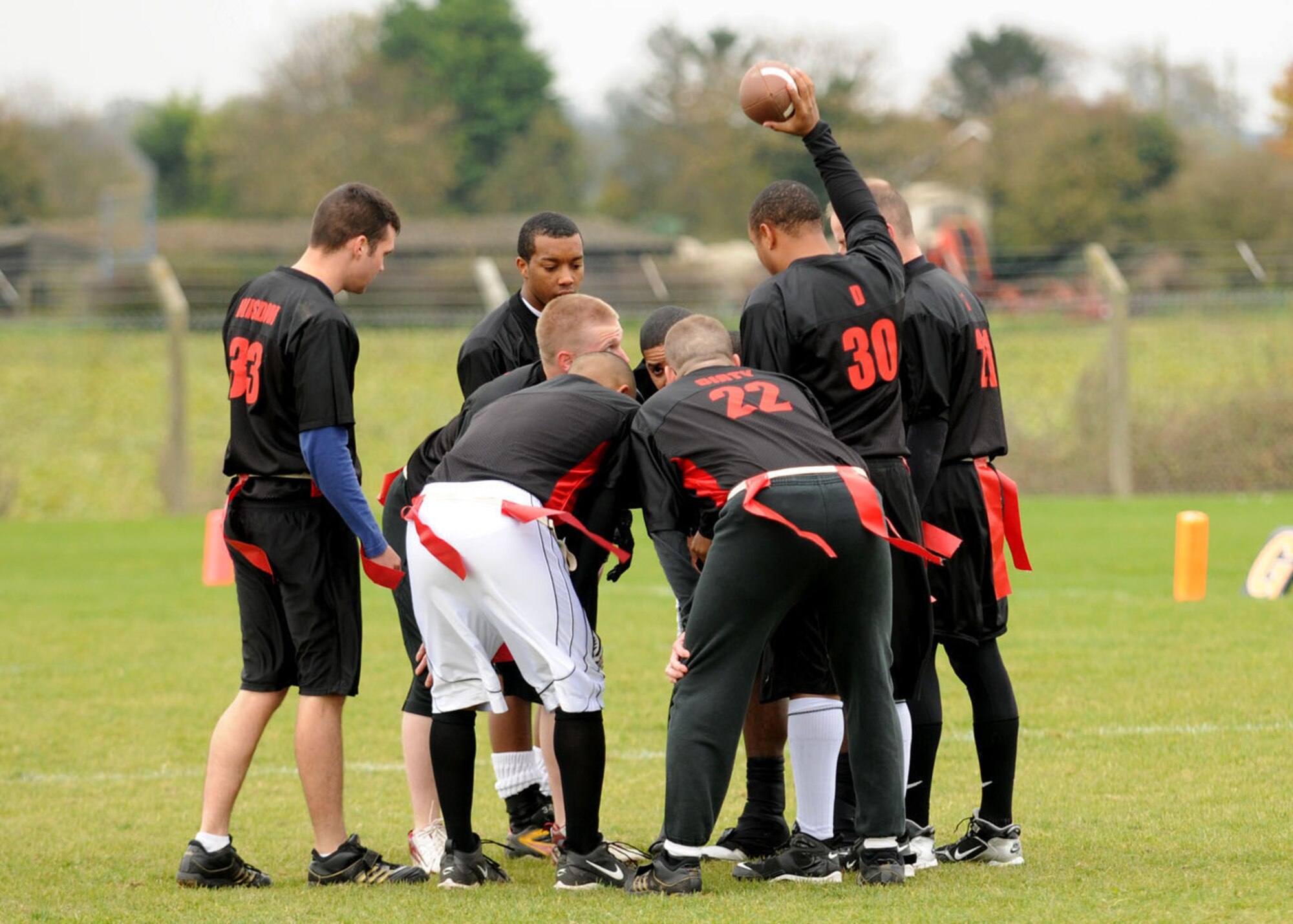 Number 30, Damien Anderson,  from the 100th Logistics Readiness Squadron holds the ball up to bring his team to a huddle during the flag football championship game Nov. 1, 2008, at RAF Mildenhall, England. The logistics readiness squadron fell 1 point short, losing to the communications squadron with a score of 14-13. (U.S. Air Force photo by Staff Sgt. Jerry Fleshman) 