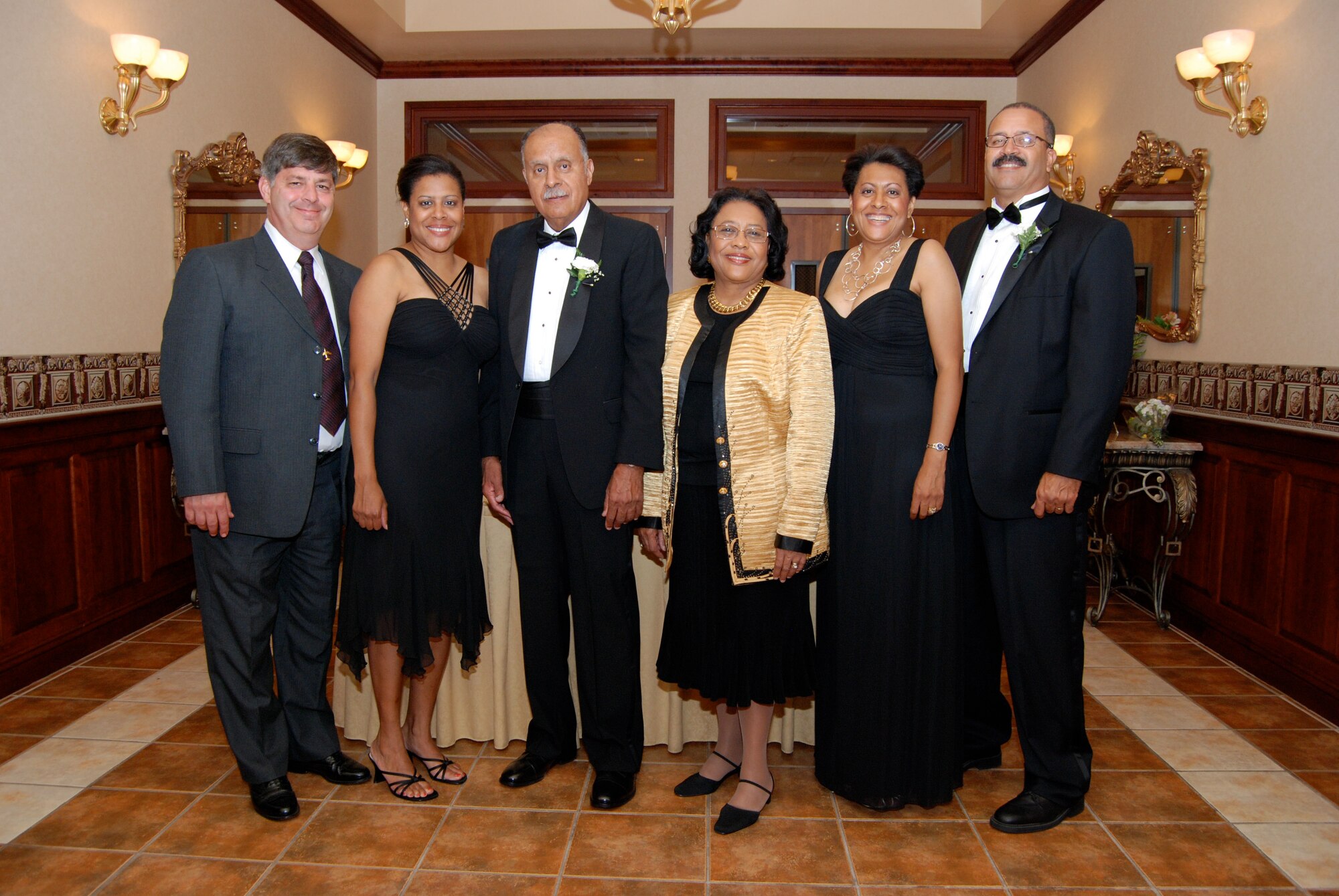 A co-wedding anniversary celebration at the Duncan Center in Dover Oct. 11 featured a current and former 512th Airlift Wing member celebrating their 25th and 50th anniversary respectively. Other members of the same family are also affiliated with the Liberty Wing. Pictured from left to right are: Lt. Col. Chris Cote, 512th AW, and his wife Maj. Leslie (Crews) Cote, Pentagon; Retired Lt. Col. Donald Crews, a member of the 512th AW when it was called the 912th Military Airlift Group, and his wife Sylvia; Lt. Col. Dawn Crews-Seams, 512th AW and her husband Wally. (U.S. Air Force photo)  