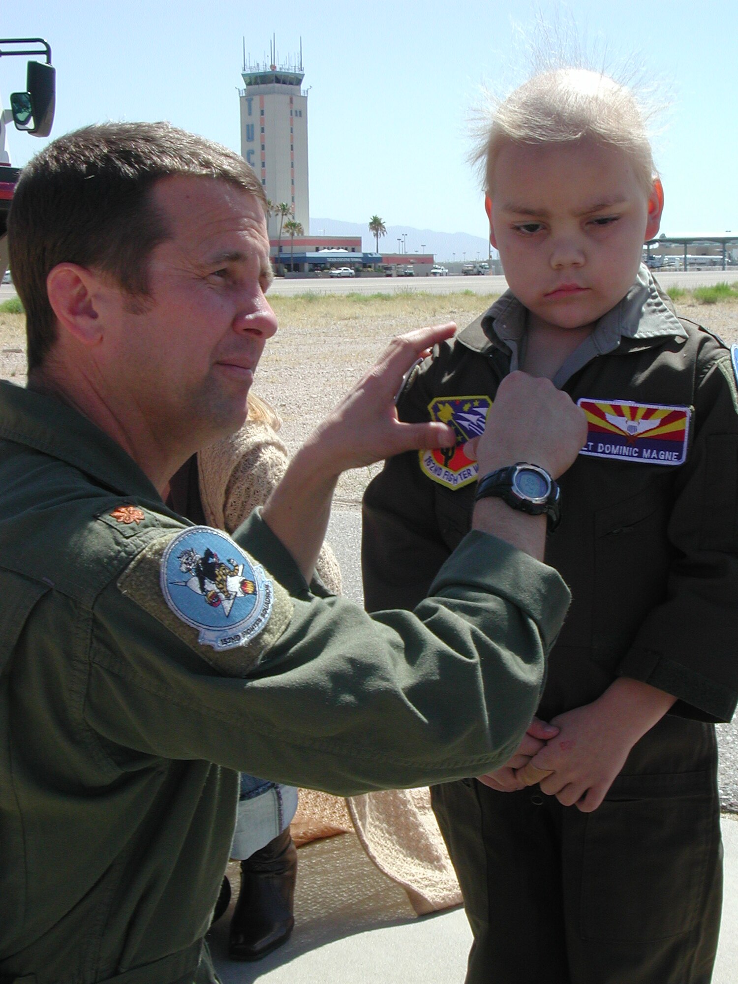 Lt. Col. Scott Reinhold, then a major, puts the 162nd Fighter Wing patch on 6-year-old Dominic Magne’s flightsuit during his visit to the Arizona Guard unit April 17, 2007. Dominic, a leukemia patient from Flagstaff, Ariz., was introduced to Colonel Reinhold through Dream Factory, a nonprofit organization that grants dreams to critically ill children. Now an honorary member of the wing, his friendship with Reinhold has grown and his health has improved. (Air National Guard photo by Capt. Gabe Johnson)