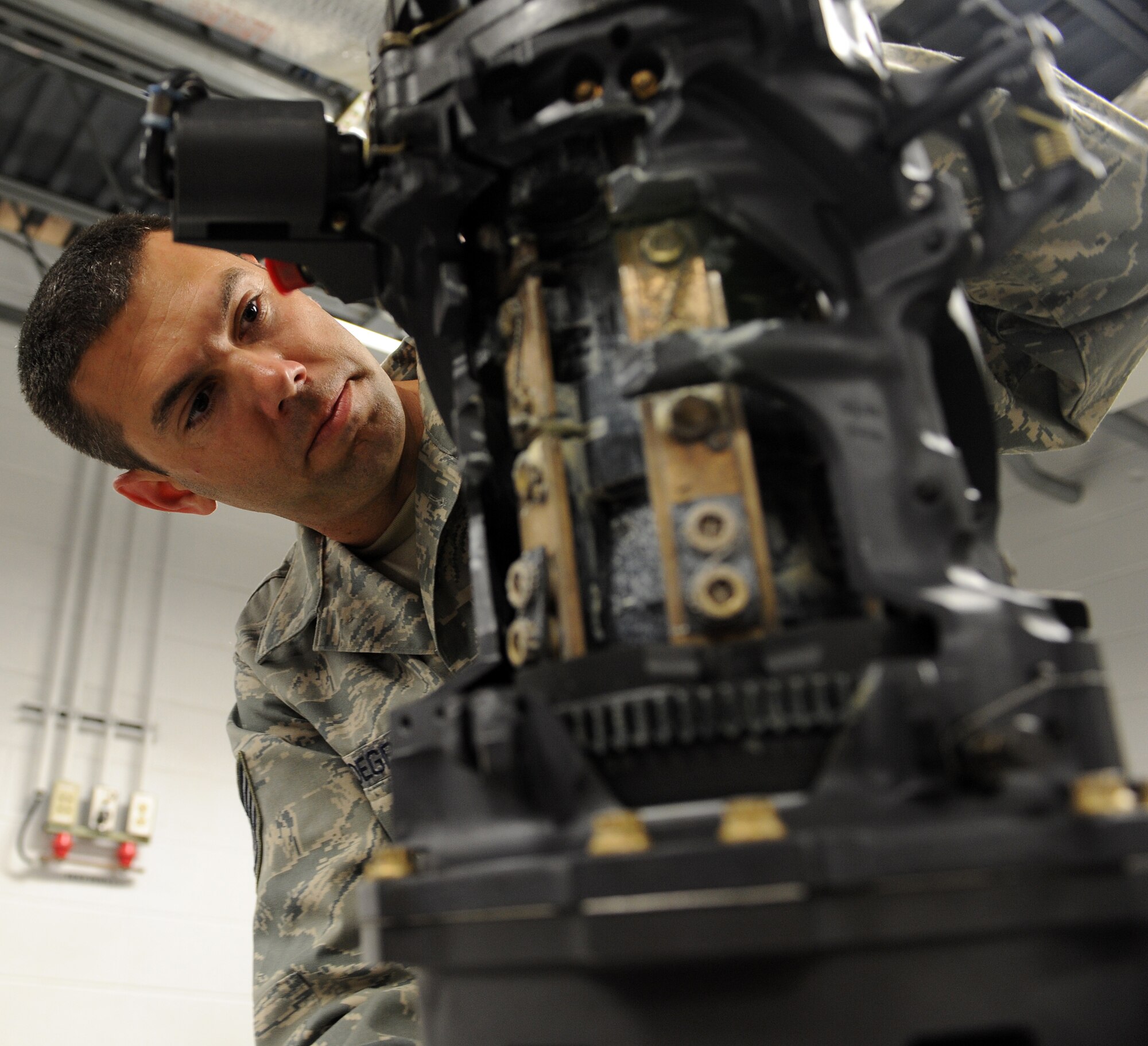 LANGLEY AIR FORCE BASE, Va. – Tech. Sgt. Michael Vandegrift, 1st Equipment Maintenance Squadron armament flight non-commissioned officer in charge of maintenance, performs a gun acceptance inspection Oct. 16. The armament flight inspects equipment that is installed on both the F-15 and F-22. Each piece of equipment carries and fires missiles or ammunition.  (U.S. Air Force Photo/Airman 1st Class Zachary Wolf)