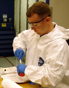 LANGLEY AIR FORCE BASE, Va. – Staff Sgt. Derek Chandler, 1st Equipment Maintenance Squadron low observable technician, mixes paste to be applied to an F-22A Raptor aircraft part Oct. 17. Langley was the first wing to have low observable, or LO, combat-coded aircraft, which necessitated the addition of a low observable section to apply and maintain the stealth coating and composite material on the F-22s.  (Photo Courtesy of Mr. Frank Geisler)