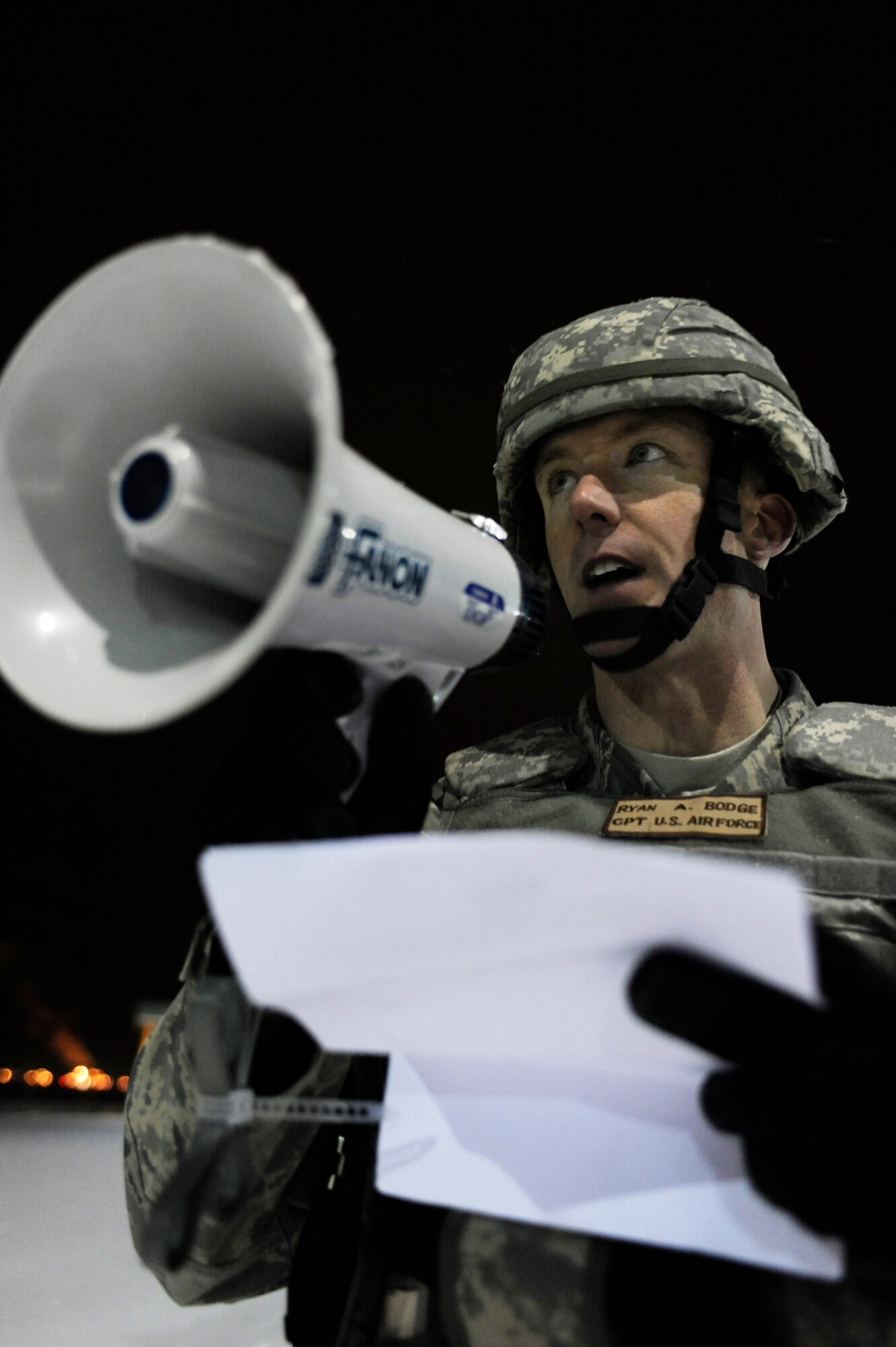 Capt. Ryan Bodge, 354th Security Forces Squadron, delivers a proclamation from the 354th Fighter Wing commander to protesters during a 354th Fighter Wing and 168th Air Refueling Wing combined Operational Readiness Exercise Nov. 3, 2008, at Eielson Air Force Base, Alaska. 354th SFS responded to protesters, simulated by Airmen, outside the front gate and quickly took control of the situation moving the protesters back to a safe location.  (U.S. Air Force photo/Senior Airman Jonathan Snyder)