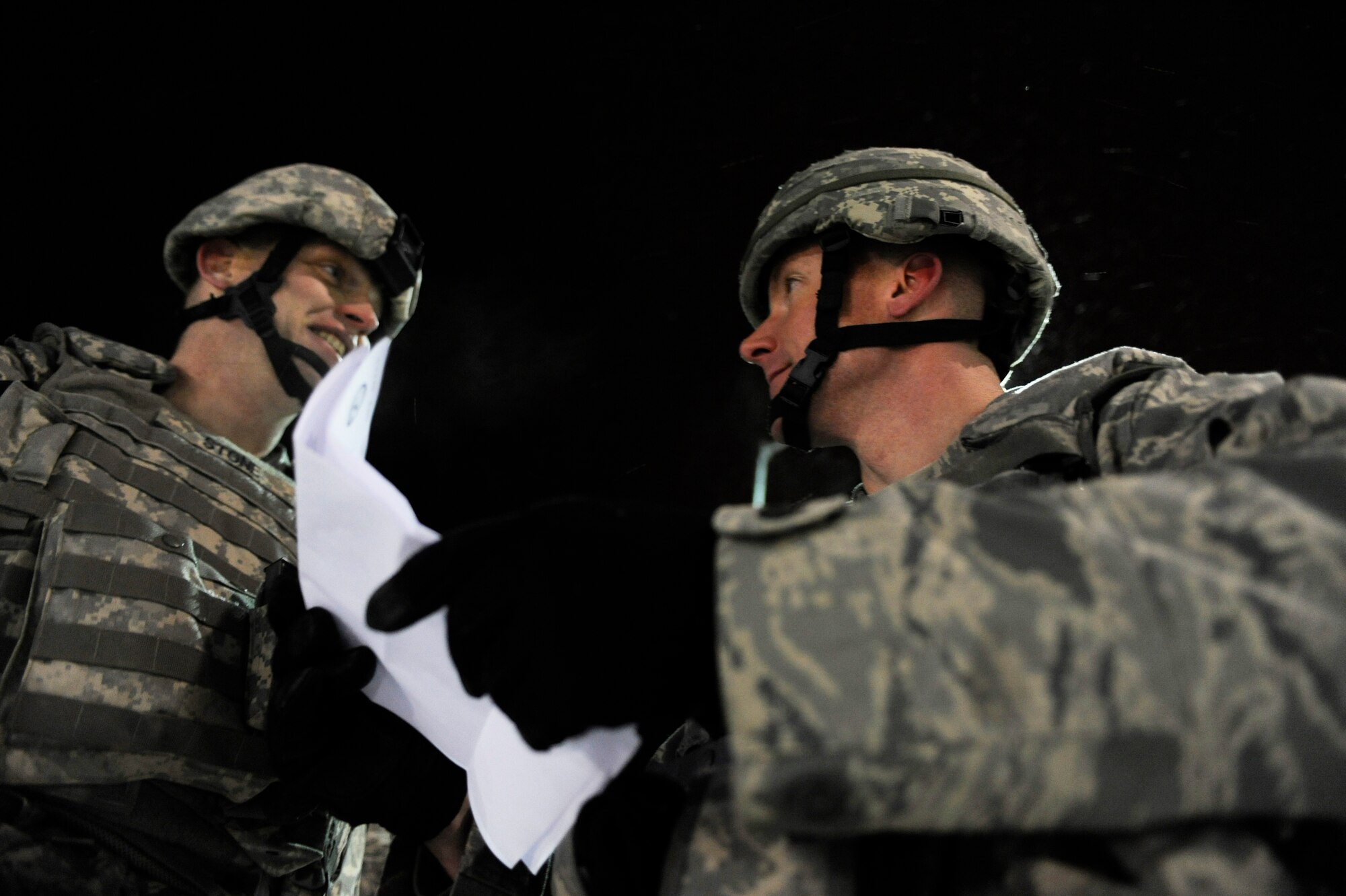 Capt. Ryan Bodge, right, arrives on scene to deliver a proclamation from the 354th Fighter Wing commander about the protest, while Master Sgt. Carroll Stone, left, explains the current situation of the Airmen simulating as protesters outside the installation during a 354th Fighter Wing and 168th Air Refueling Wing combined Operational Readiness Exercise Nov. 3, 2008, at Eielson Air Force Base, Alaska. The exercise trains Airmen how to handle different situations that during a mass deployment to support operations in the Pacific Region. Both Airmen are assigned to the 354th Security Forces Squadron. (U.S. Air Force photo/Senior Airman Jonathan Snyder)