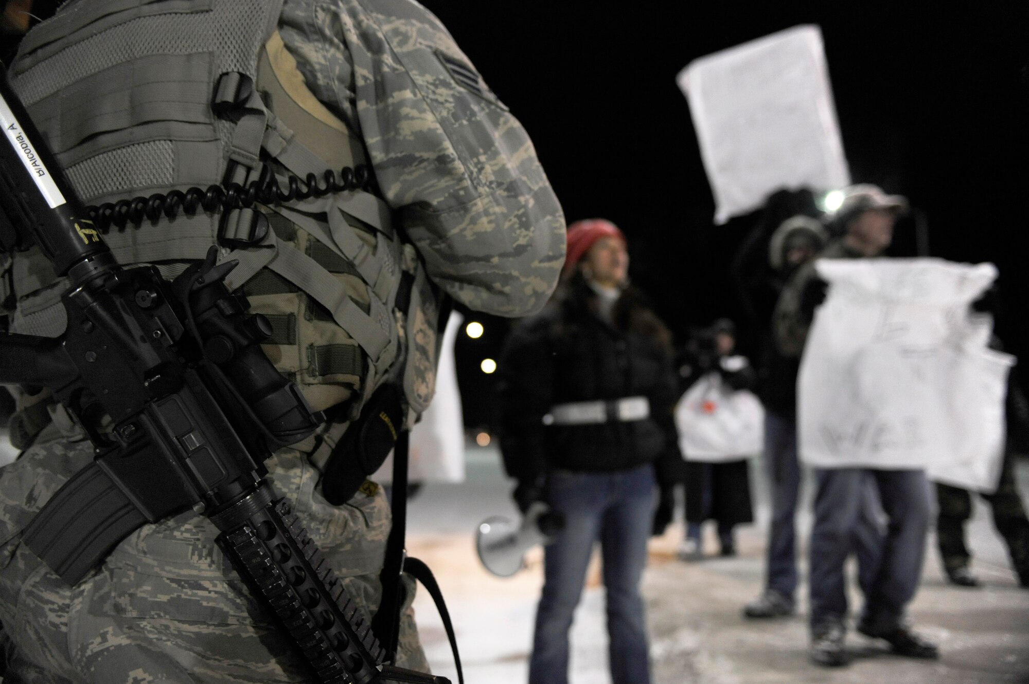 Senior Airman Anthony Alcobia, 354th Security Forces Squadron, stands guard at Hursey Gate stopping Airmen simulating as protesters from entering onto the installation during a 354th Fighter Wing and 168th Air Refueling Wing combined Operational Readiness Exercise Nov. 3, 2008, at Eielson Air Force Base, Alaska. The exercise trains Airmen how to handle different situations during a mass deployment to support operations in the Pacific Region. (U.S. Air Force photo/Senior Airman Jonathan Snyder)