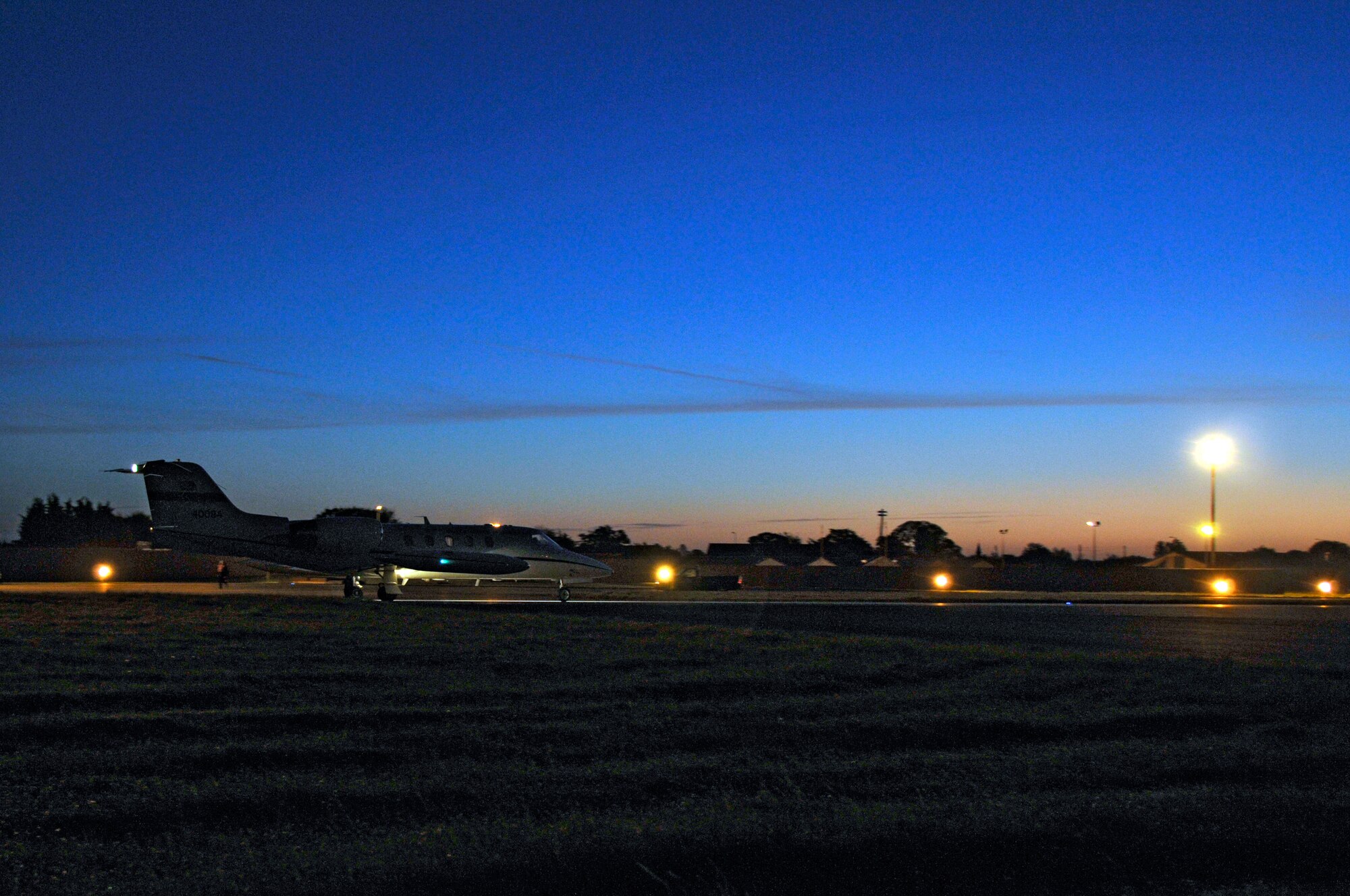 A C-21 taxis in to transport mail and absentee ballots to Airman deployed to Lithuania Oct. 25 at RAF Mildenhall, England. The 493rd Fighter Squadron stationed at RAF Lakenheath, is currently depolyed to Lithuania in support of a 3 months NATO Baltic air policing mission. (U.S. Air Force photo by Airman 1st Class Perry Aston)