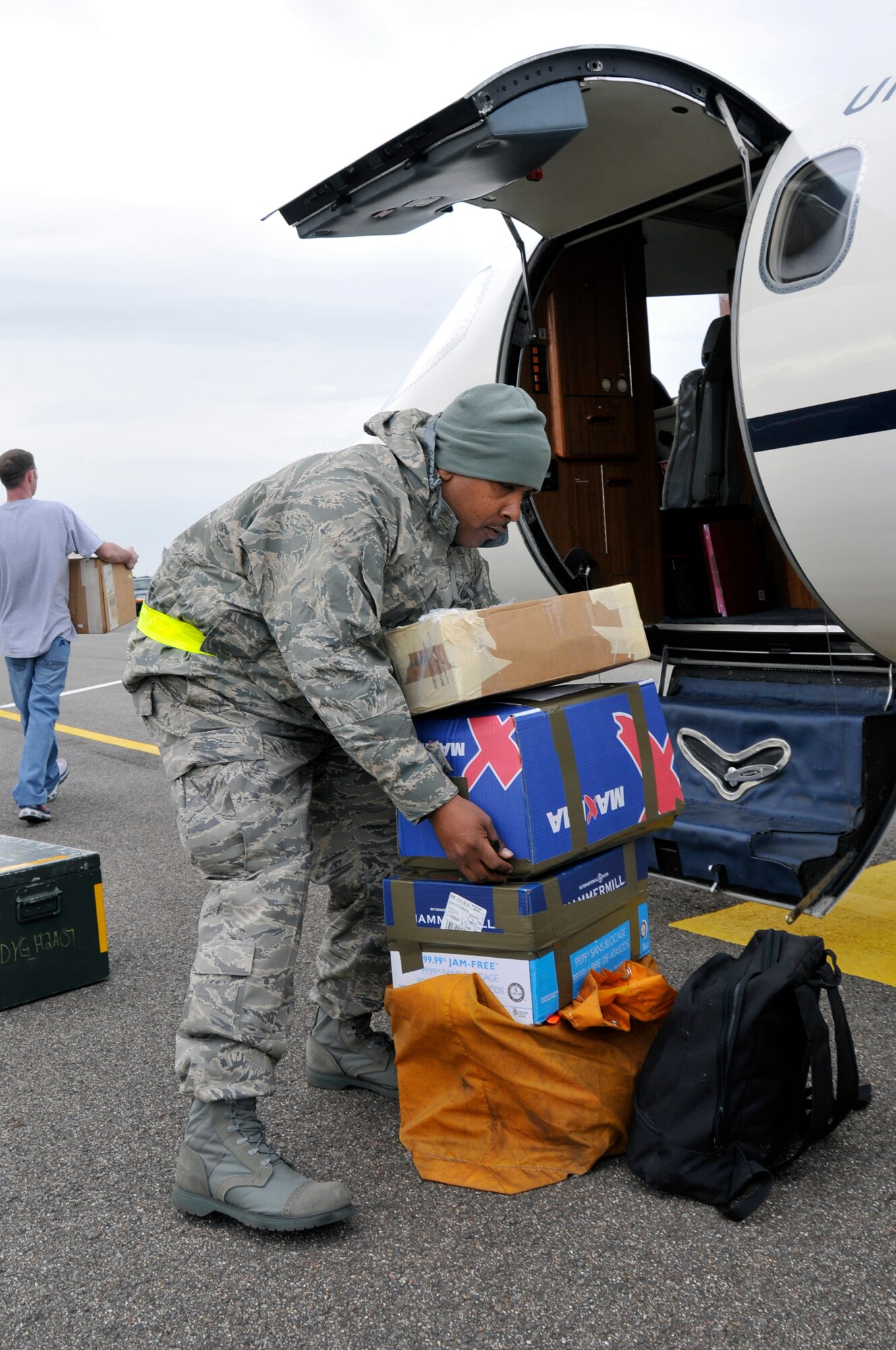 Master Sgt. Tyrone Curl, 48th Communications Squadron postmaster, unloads mail and absentee ballots from a C-21 Oct. 25 at RAF Mildenhall, England. Master Sgt. Curl escorted mail and absentee ballots to Lithuania for Airmen deployed to a NATO Baltic air policing mission. (U.S. Air Force photo by Airman 1st Class Perry Aston)