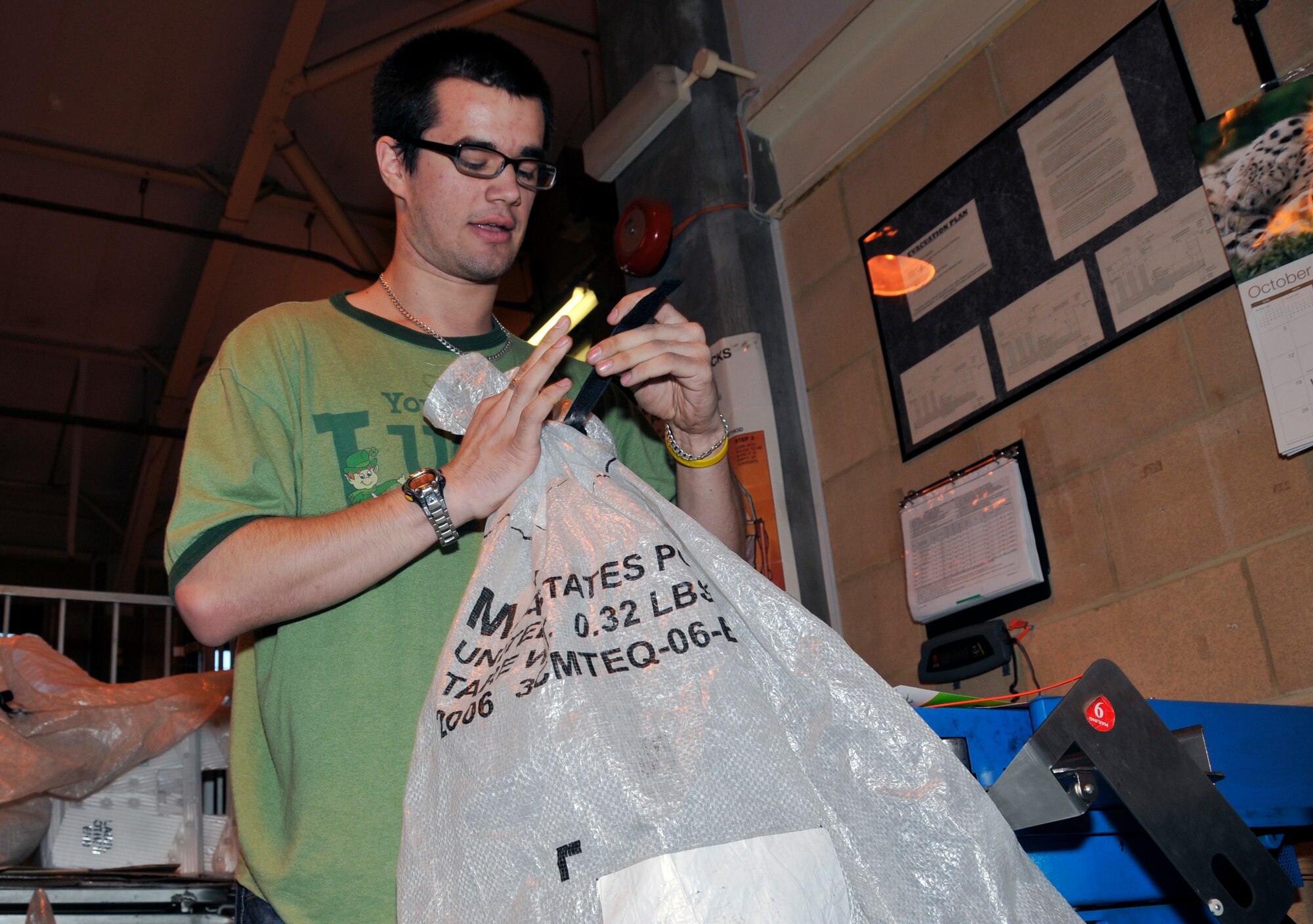 James Williams, 48th Communications Squadron postal clerk, secures a postal bag filled with absentee ballots Oct. 29 at RAF Lakenheath, England. Customers can have their ballots mailed via Express mail 3-day service, free of charge. (U.S. Air Force photo by Airman 1st Class Perry Aston) 