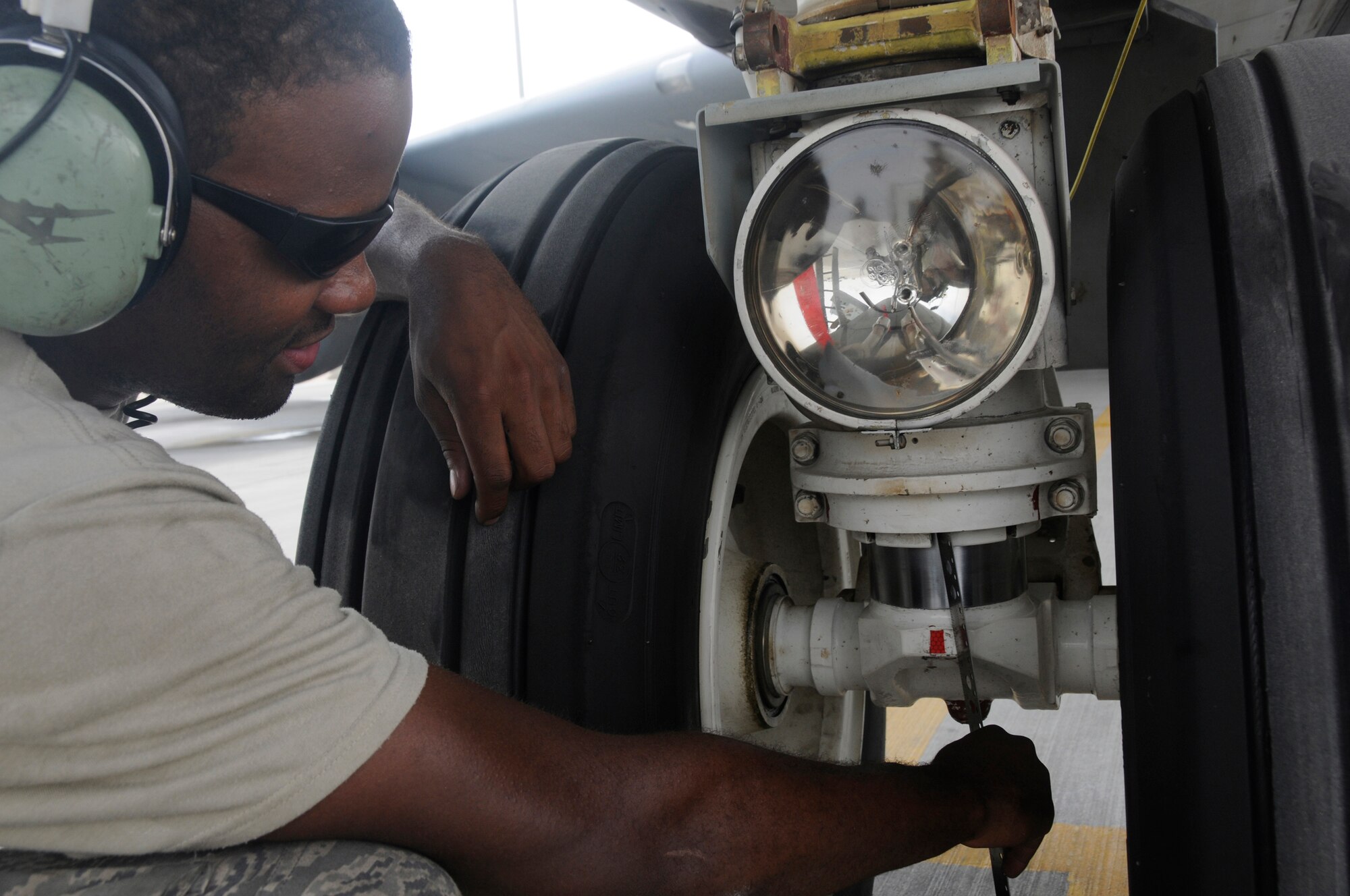 Airman 1st Class Jermie Hunt, crew chief assigned to the 379th Expeditionary Aircraft Maintenance Squadron, measures the nose strut of a KC-135 Stratotanker to ensure it is extended the proper length relative to the aircraft's weight Nov. 3, at an undisclosed air base in Southwest Asia.  379th EMXS crew chiefs are responsible for recovering aircraft after missions and ensuring they are prepared for their next launch supporting Operations Iraqi and Enduring Freedom and Joint Task Force-Horn of Africa. Airman Hunt, a native of Dallas, Texas, is deployed from Grand Forks Air Force Base, N.D.  (U.S. Air Force photo by Staff Sgt. Darnell T. Cannady/Released)