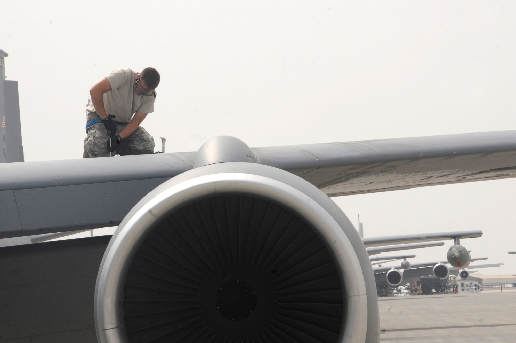 Airman 1st Class Jason Whitbeck, crew chief assigned to the 379th Expeditionary Aircraft Maintenance Squadron, tightens airlocks on a KC-135 Stratotanker wing to ensure panels won?t come off during flight Nov. 3, at an undisclosed air base in Southwest Asia. 379th EMXS crew chiefs are responsible for recovering aircraft after missions and ensuring they are prepared for their next launch supporting Operations Iraqi and Enduring Freedom and Joint Task Force-Horn of Africa.  Airman Whitbeck, a native of Rochester, N.Y., is deployed from Grand Forks Air Force Base, N.D.  (U.S. Air Force photo by Staff Sgt. Darnell T. Cannady/Released)