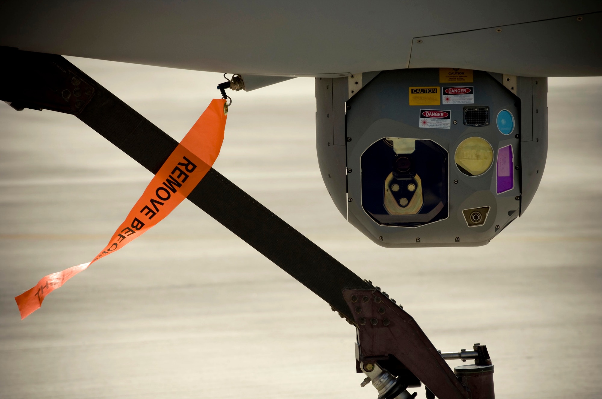 The camera of an MQ-1 Predator "looks" at the camera during a sensor functionality check at a base in southern Afghanistan, Oct. 25. The Predator aircraft carries a Multi-spectral Targeting System integrating electro-optical, infrared, laser designator and laser illuminator into a single sensor package. This allows the sensor operator to see under virtually any circumstances. (U.S. Air Force photo by Staff Sgt. Samuel Morse/Released)