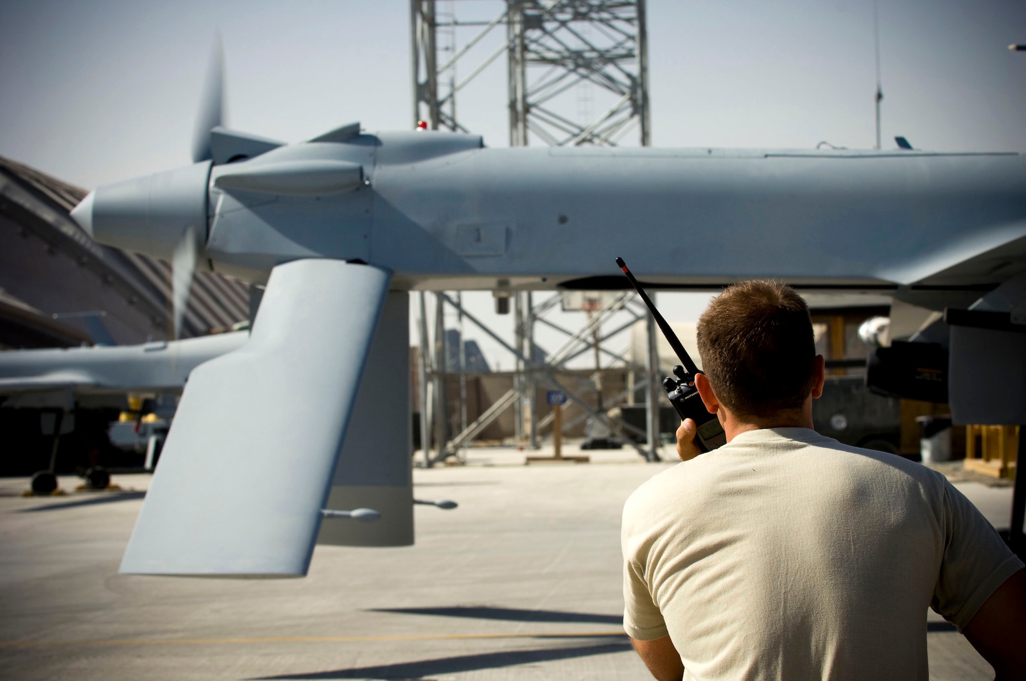 Airman 1st Class Justin Cole, 62nd Expeditionary Reconnaissance Squadron crew chief, monitors the engine and propeller of an MQ-1 Predator as it starts up at a base in southern Afghanistan, Oct. 25. With the pilot and sensor operator inside the ground control station, they rely heavily on communication via radio with their crewchiefs to have a successful launch. Airman Cole is deployed from the 432nd Aircraft Maintenance Squadron, Creech Air Force Base, Nevada, and hails from Orange Park, Fla. (U.S. Air Force photo by Staff Sgt. Samuel Morse/Released)