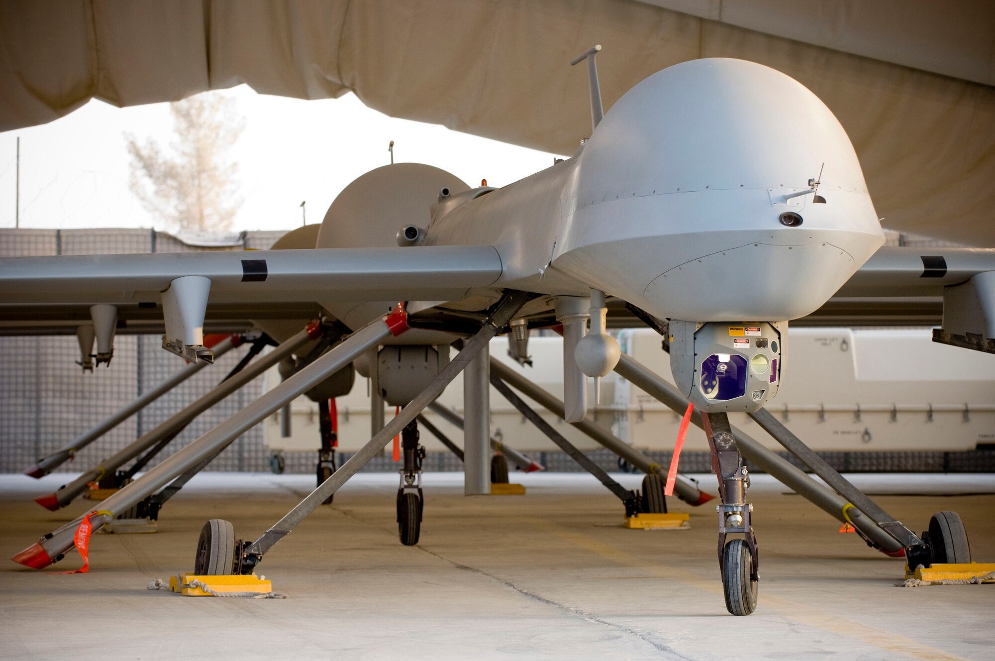 Three MQ-1 Predators sit ready for launch in a hangar at a base in southern Afghanistan, Oct. 25. The Predator is a multi-role attack reconnaissance unmanned aircraft system incorporating advanced surveillance capabilities with the offensive power of two AGM-114 Hellfire missiles. (U.S. Air Force photo by Staff Sgt. Samuel Morse/Released)