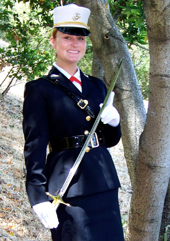 Marine Midshipman 1st Class Lauren Reisinger stands in dress uniform during a visit to her home in Marin County, Calif., June, 29, 2008. Reisinger is on a leave of absence while she attends the University of Jordan on a Defense Department scholarship to study the Arabic culture and language. She is holding a Mameluke sword with her name engraved on it, which she received in connection with the Professor of Military Science Award, the highest honor given to one midshipman each year. Courtesy photo