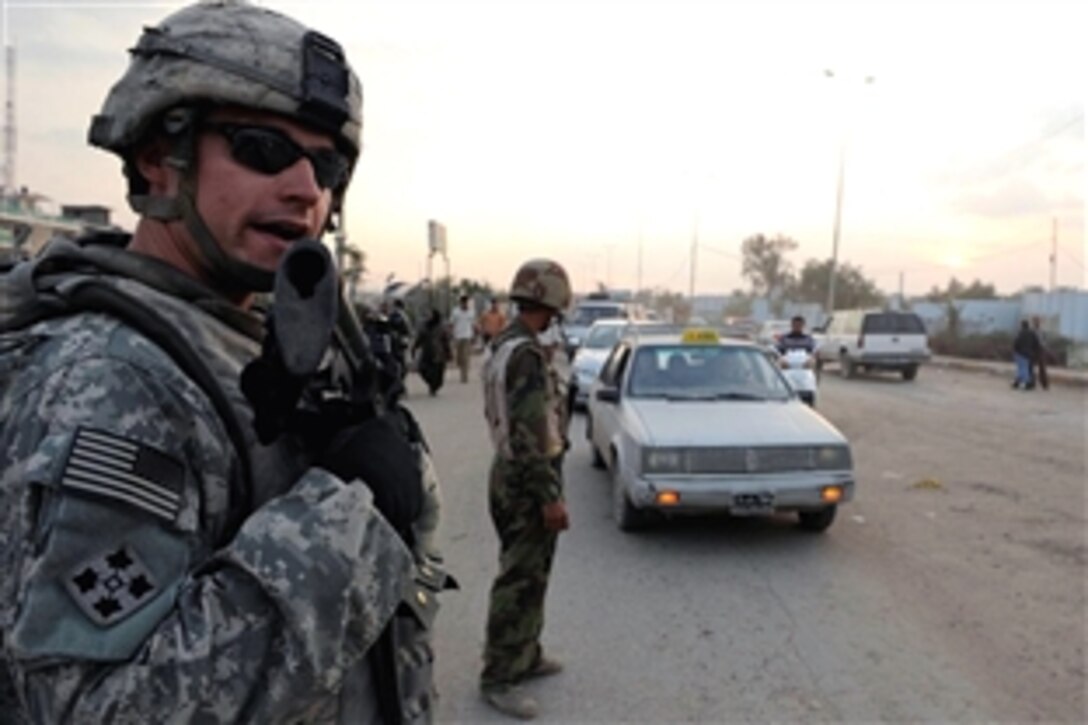 U.S. Army Sgt. Will Fout stops by a checkpoint to see if Iraqi army soldiers manning the post need supplies or equipment as he patrols in the city of  Baghdad, Iraq, Oct. 30, 2008. Fout and fellow soldiers are assigned to the 4th Infantry Division's Command Security Detachment, 3rd Brigade Combat Team.